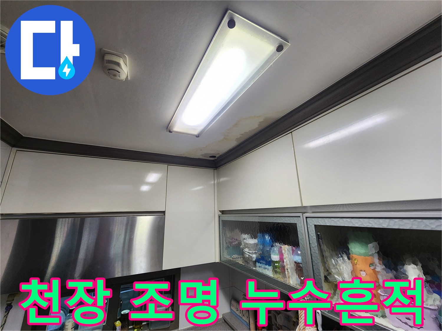 주방 천장 조명 패널 옆의 물 얼룩 현상