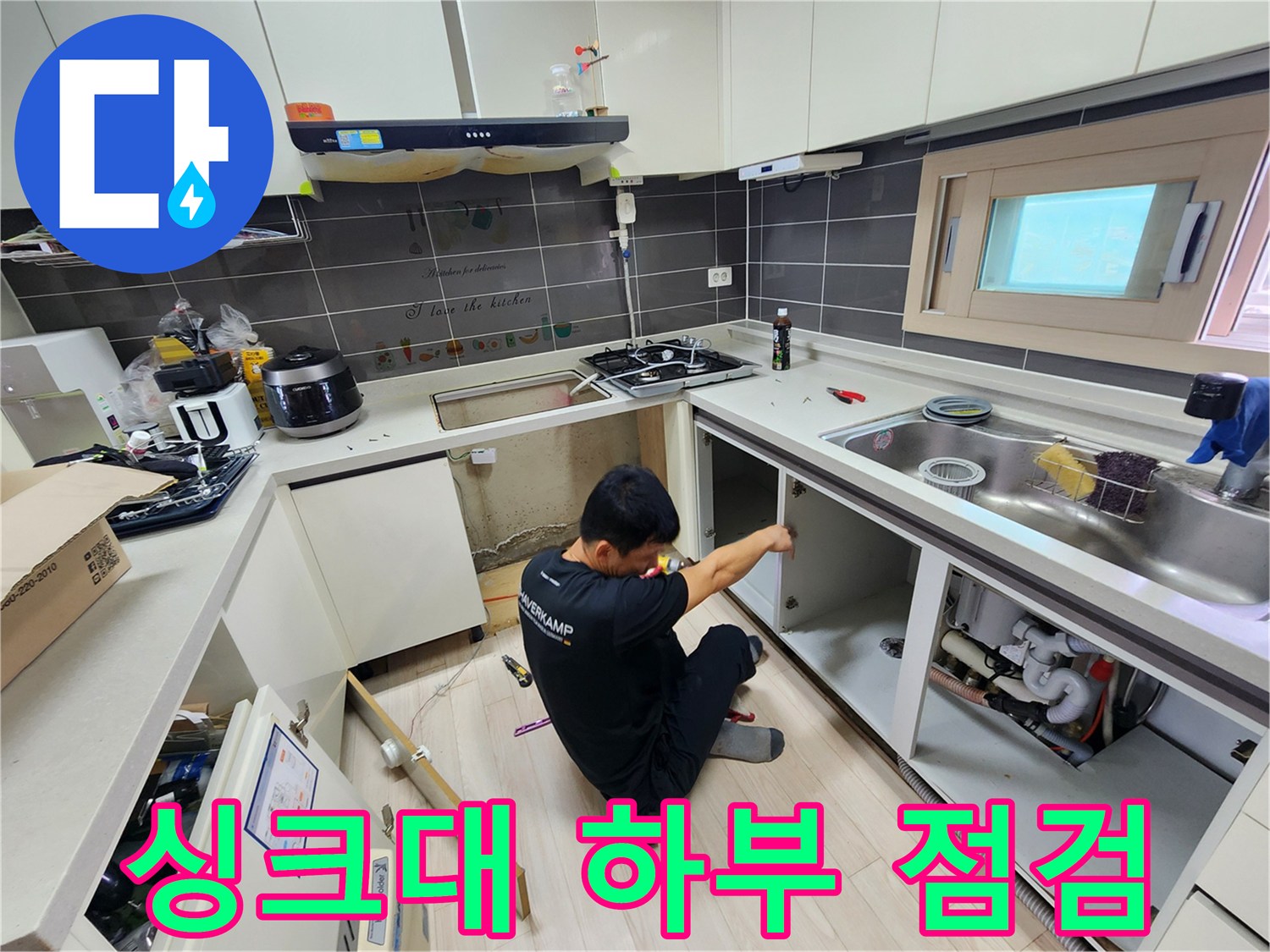 싱크대 하부장을 탈거하여 배관 상태를 점검하는 모습