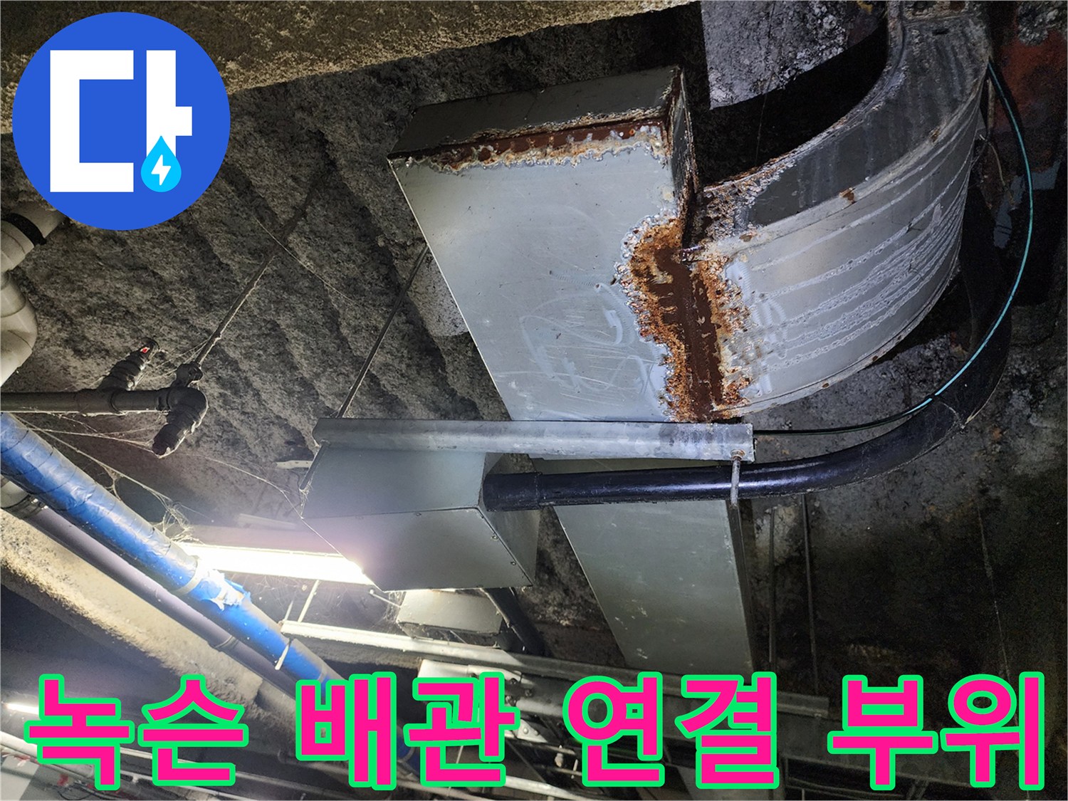 천장에 설치된 금속 배관의 심한 녹과 부식 상태를 보여줍니다.