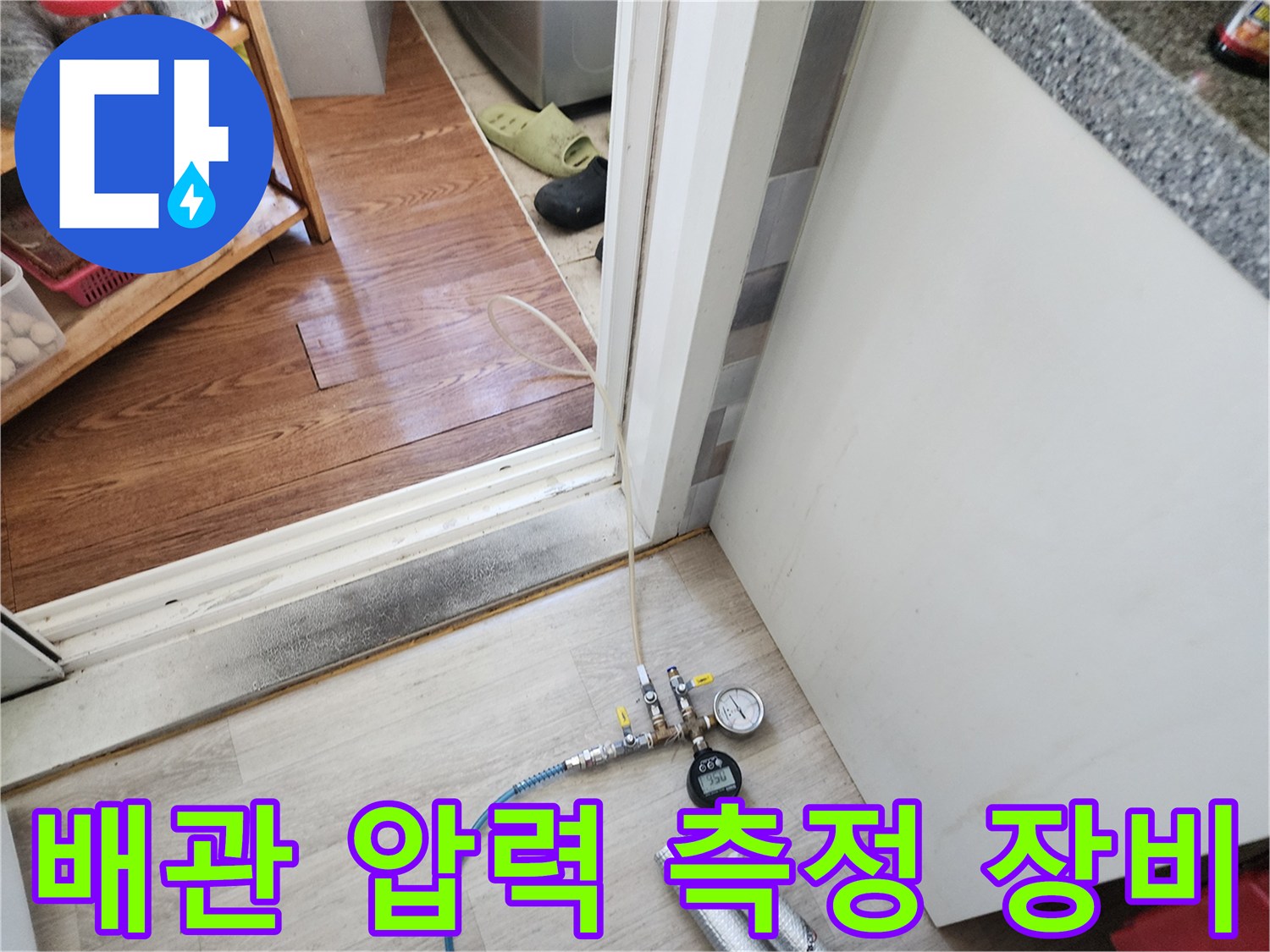 보일러실 바닥에 설치된 배관 압력계와 가스 주입용 호스
