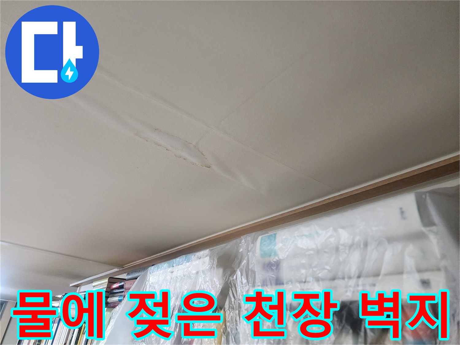 천장 벽지가 수분을 흡수하여 불룩하게 변형된 상태를 보여줍니다.