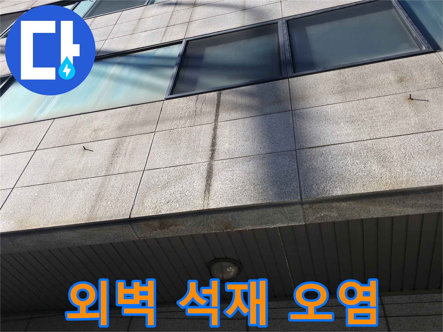 석재 마감재 표면에 나타난 세로 방향의 수분 침투 흔적과 얼룩
