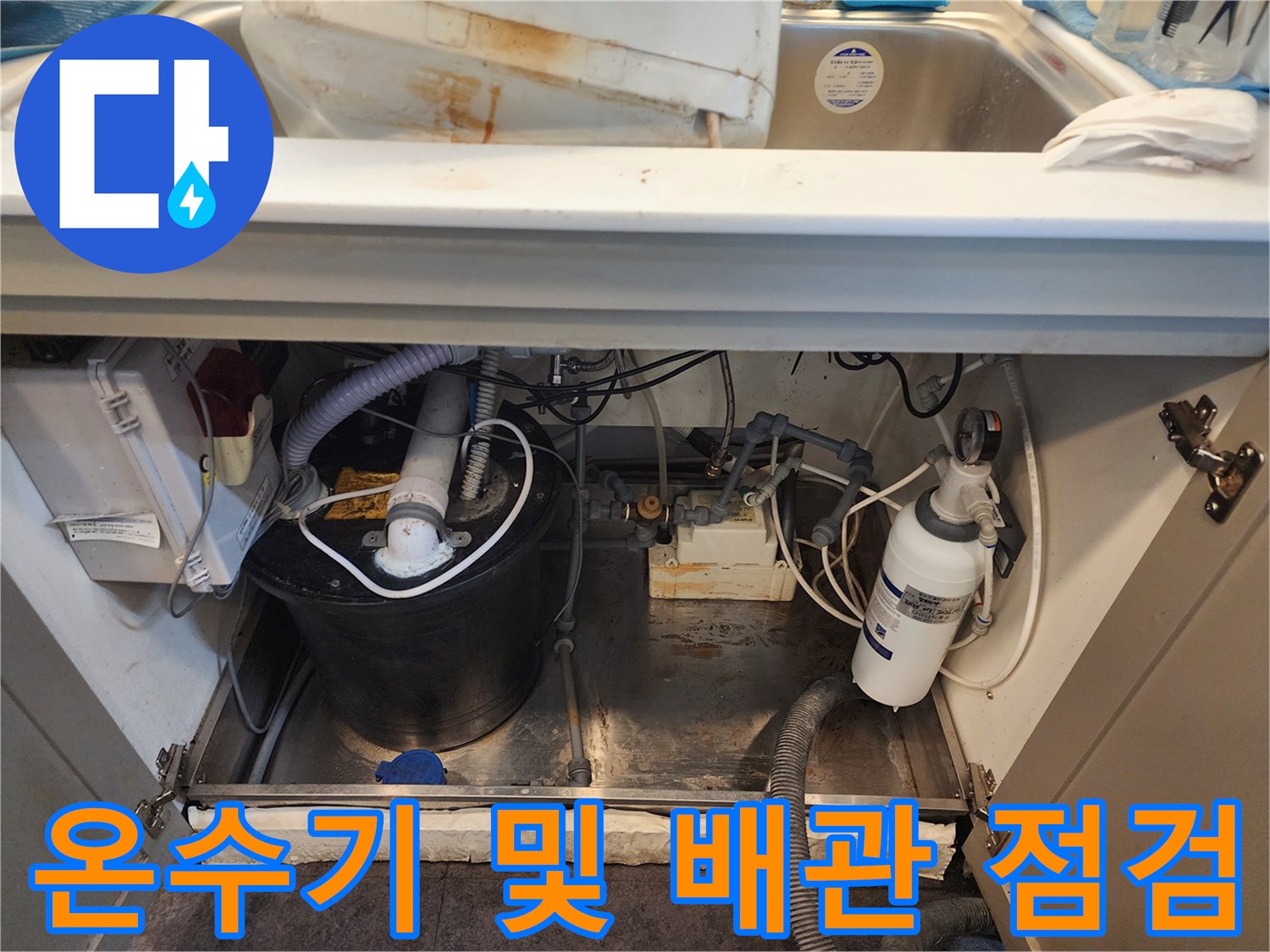 싱크대 아래 온수기와 수평으로 배치된 배관들의 누수 진단 모습