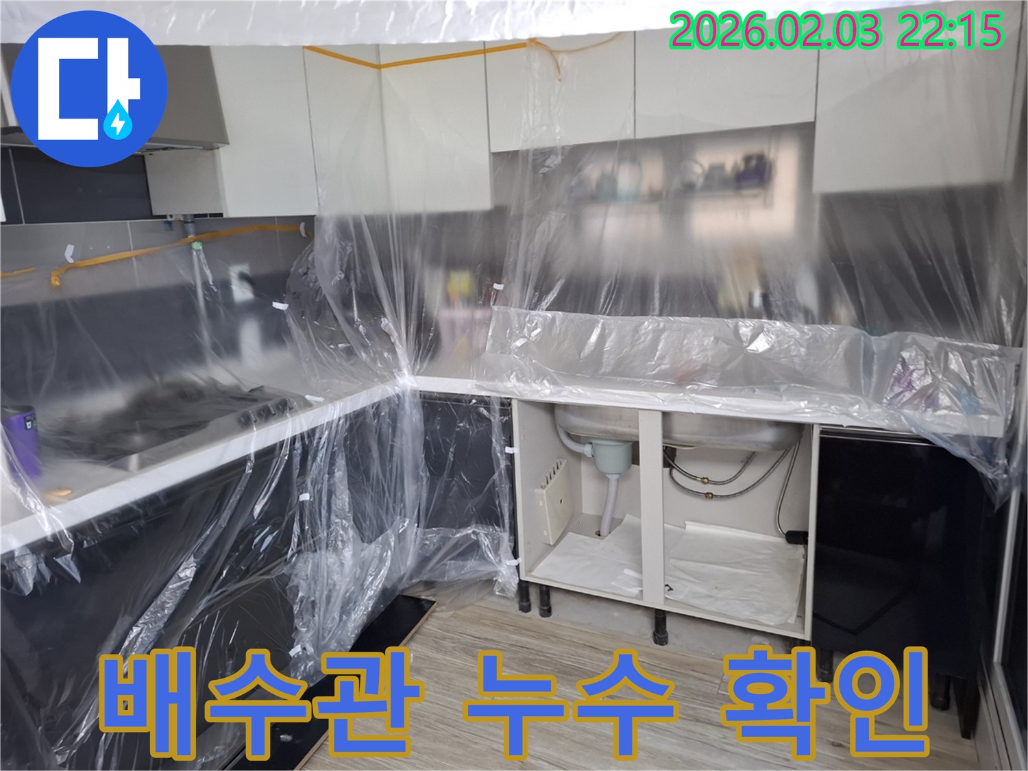 배수관 누수 확인 - 씽크대 배수관 연결 부위에서 누수 흔적을 발견하고 꼼꼼하게 확인하고 있습니다.
