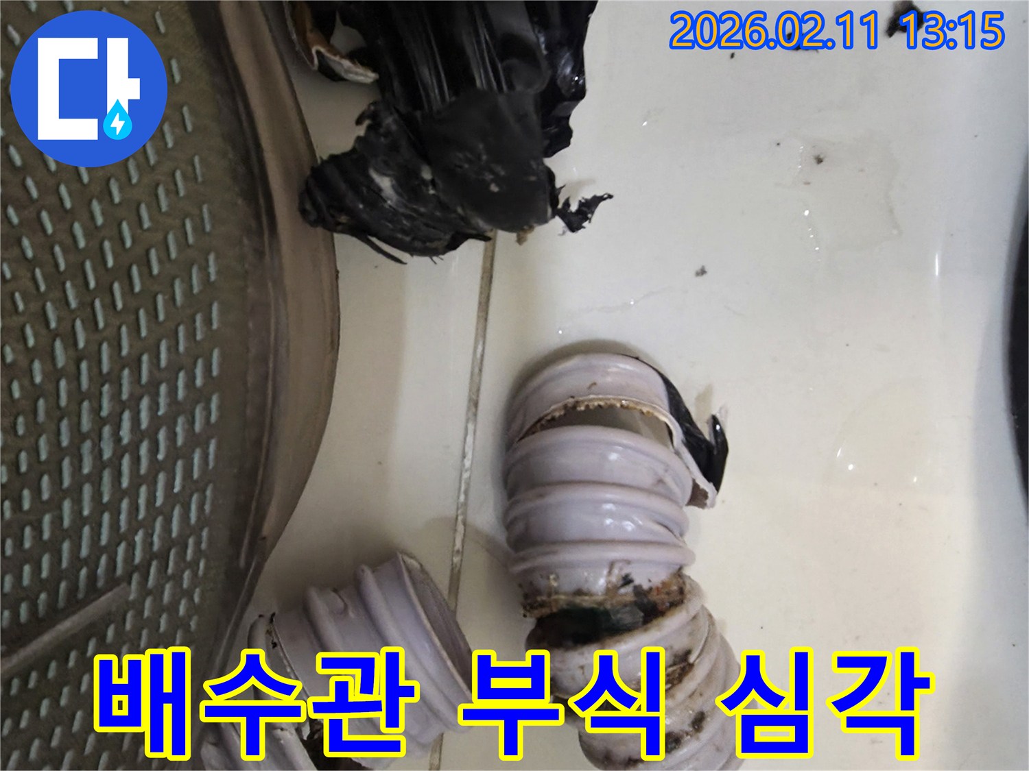 오랜 사용으로 인해 심하게 부식되고 찢어진 배수 호스-누수 문제의 직접적인 증거를 보여주는 이미지