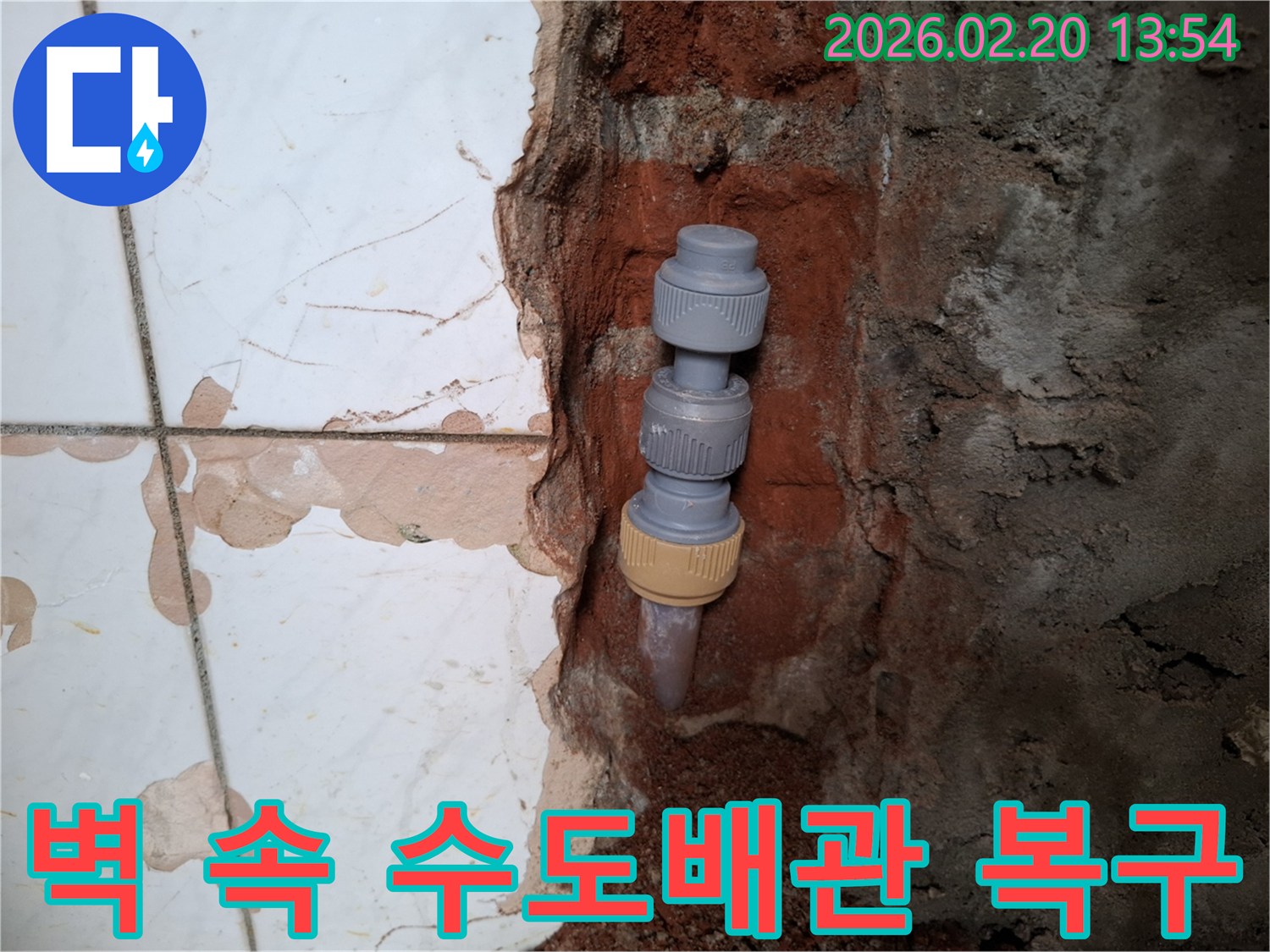 벽을 개방하여-드러난-수도배관의-누수 지점을-새로운 연결 부품으로-복구하는-작업 현장입니다.