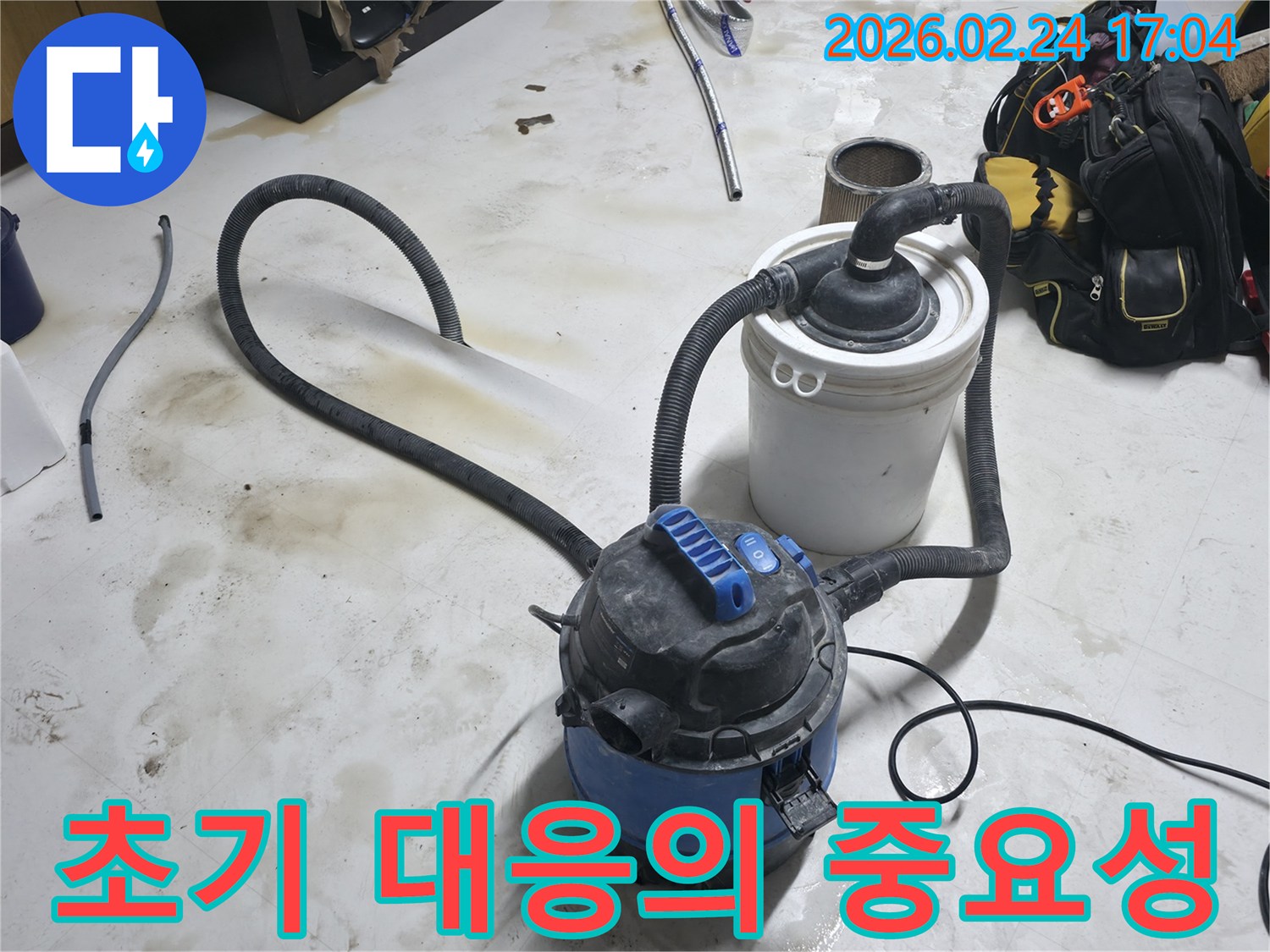 누수 발생 시 초기 대응으로 습식 청소기를 이용해 물기를 제거하는 중요한 작업 현장