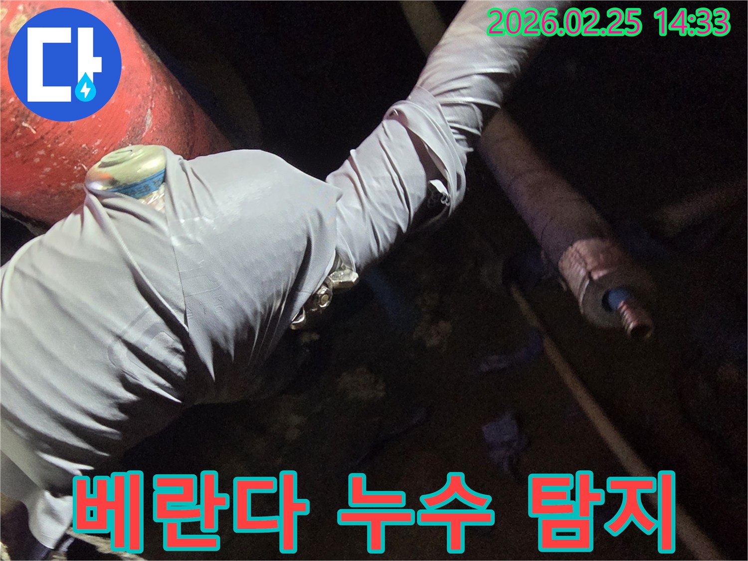 누수-전문가가-아파트-베란다-누수-원인을-찾기 위해-배관에-탐지-장비를-연결하는-사진