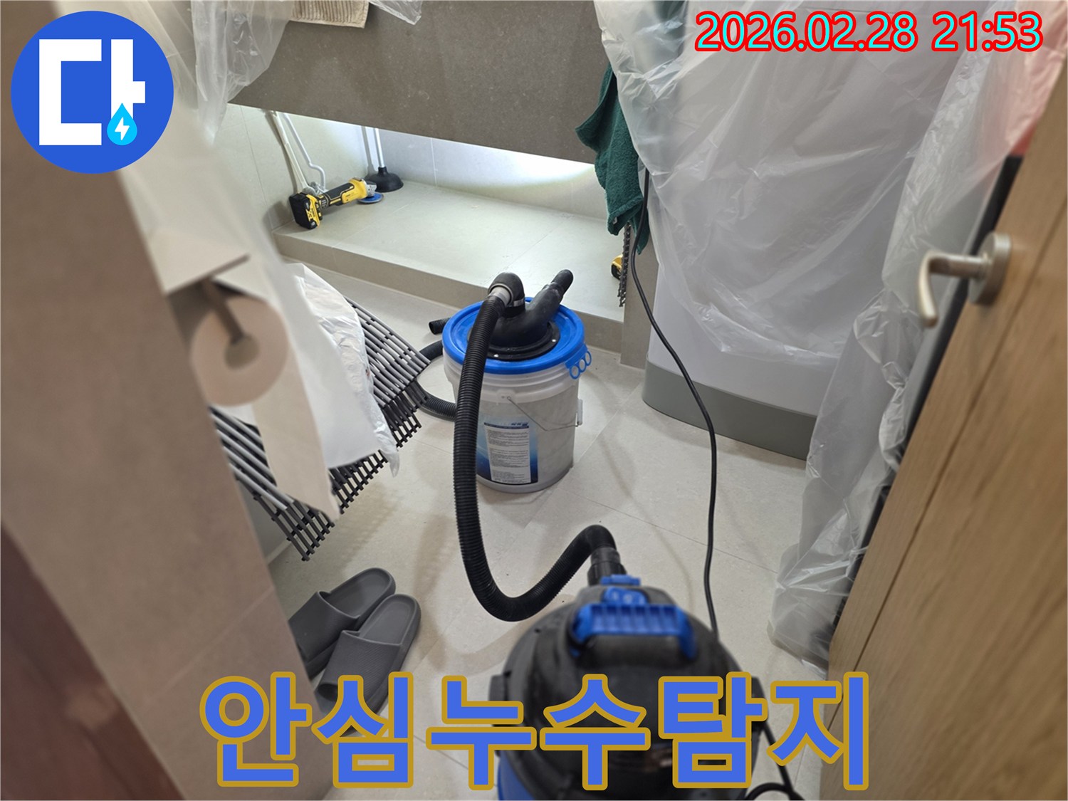 이 이미지는 누수 탐지 작업을 통해-고객님이 안심하고 맡길 수 있도록-주변을 비닐로 보양하고-습식 청소 장비를 설치하는 모습을 보여줍니다.