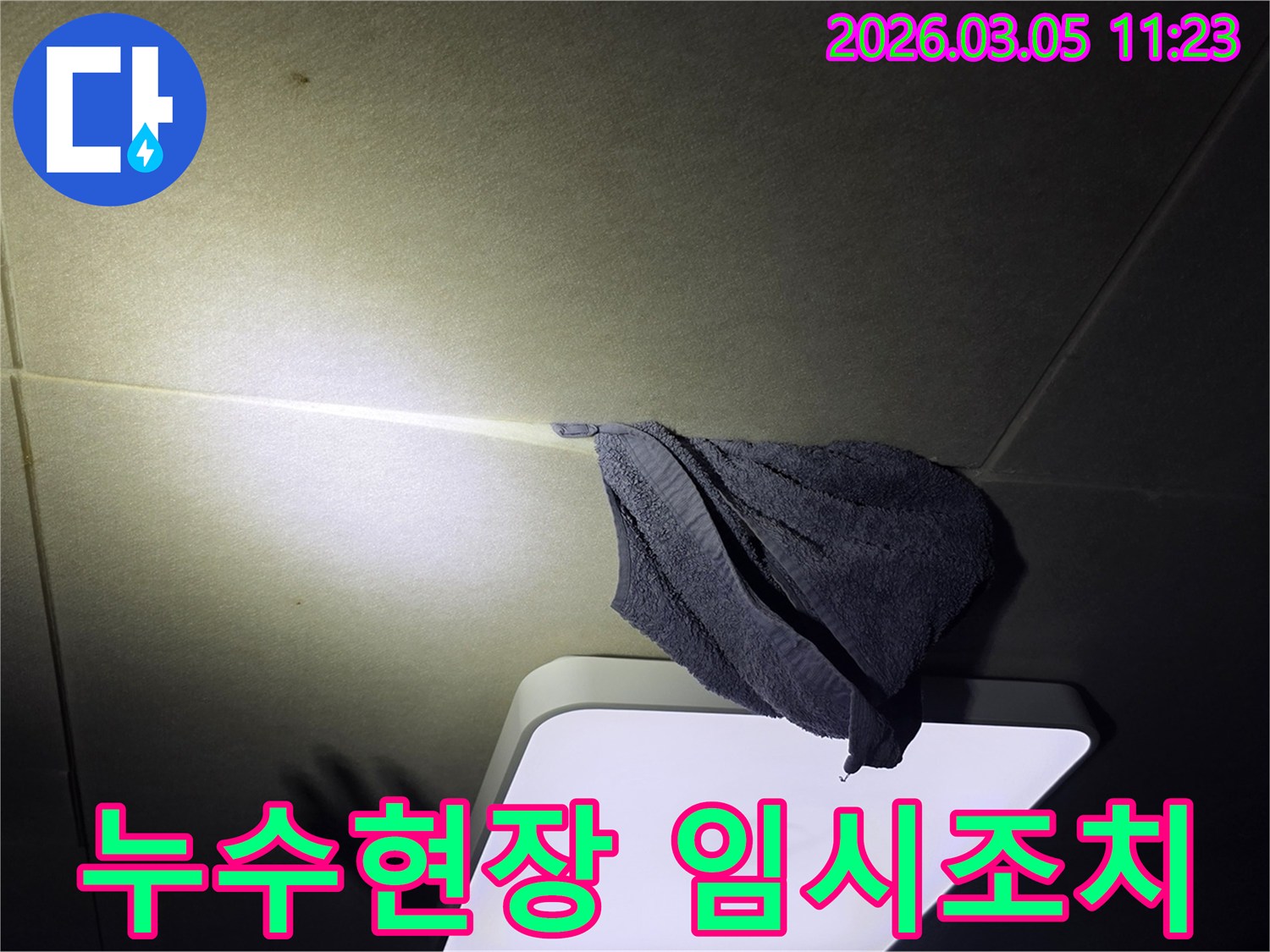 천장에서-물이-새어-나와-수건으로-받고-있는-긴급-누수-상황을-보여주는-이미지