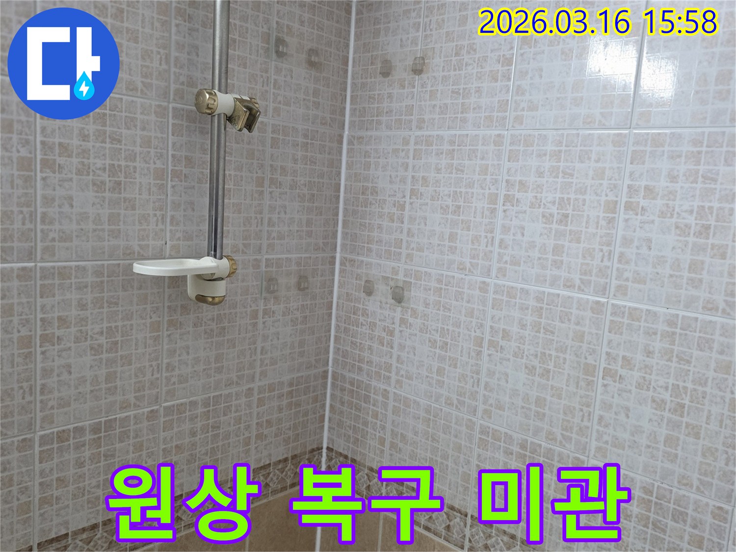 욕실 천장 타일에 물이 새어 생긴-얼룩을 제거한 후 원상 복구하여-미관을 개선하는 누수 전문가의 모습