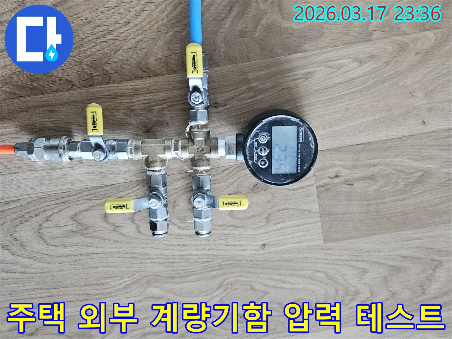 주택 외부 수도 계량기함 배관의 미세한 누수도 놓치지 않기 위해-정밀 압력계를 연결하여-압력 강하를 측정하는 모습입니다.