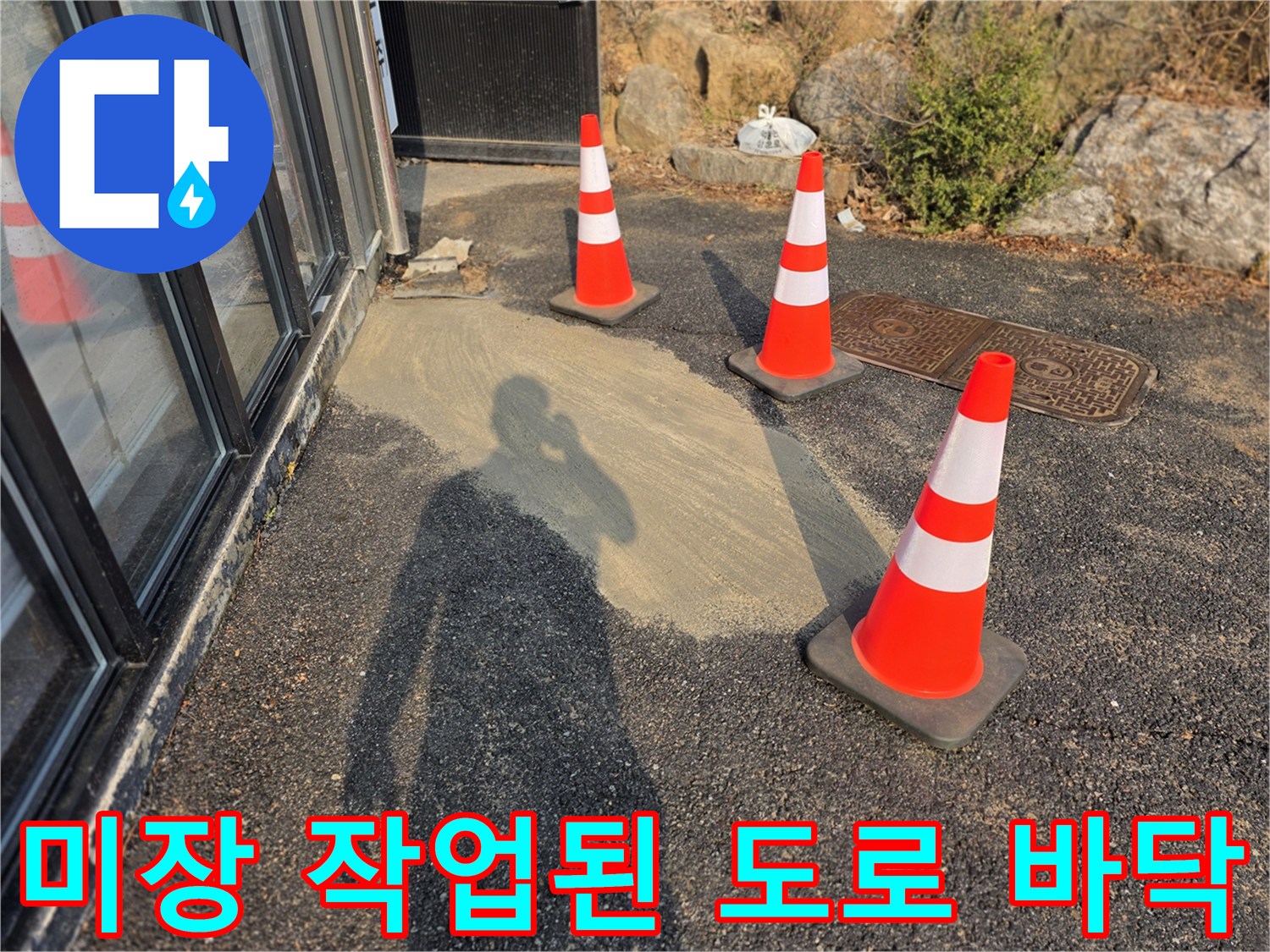 도로 굴착 부위를 메우기 위해 시멘트 미장을 진행하고 안전을 위해 설치한 라바콘 사진