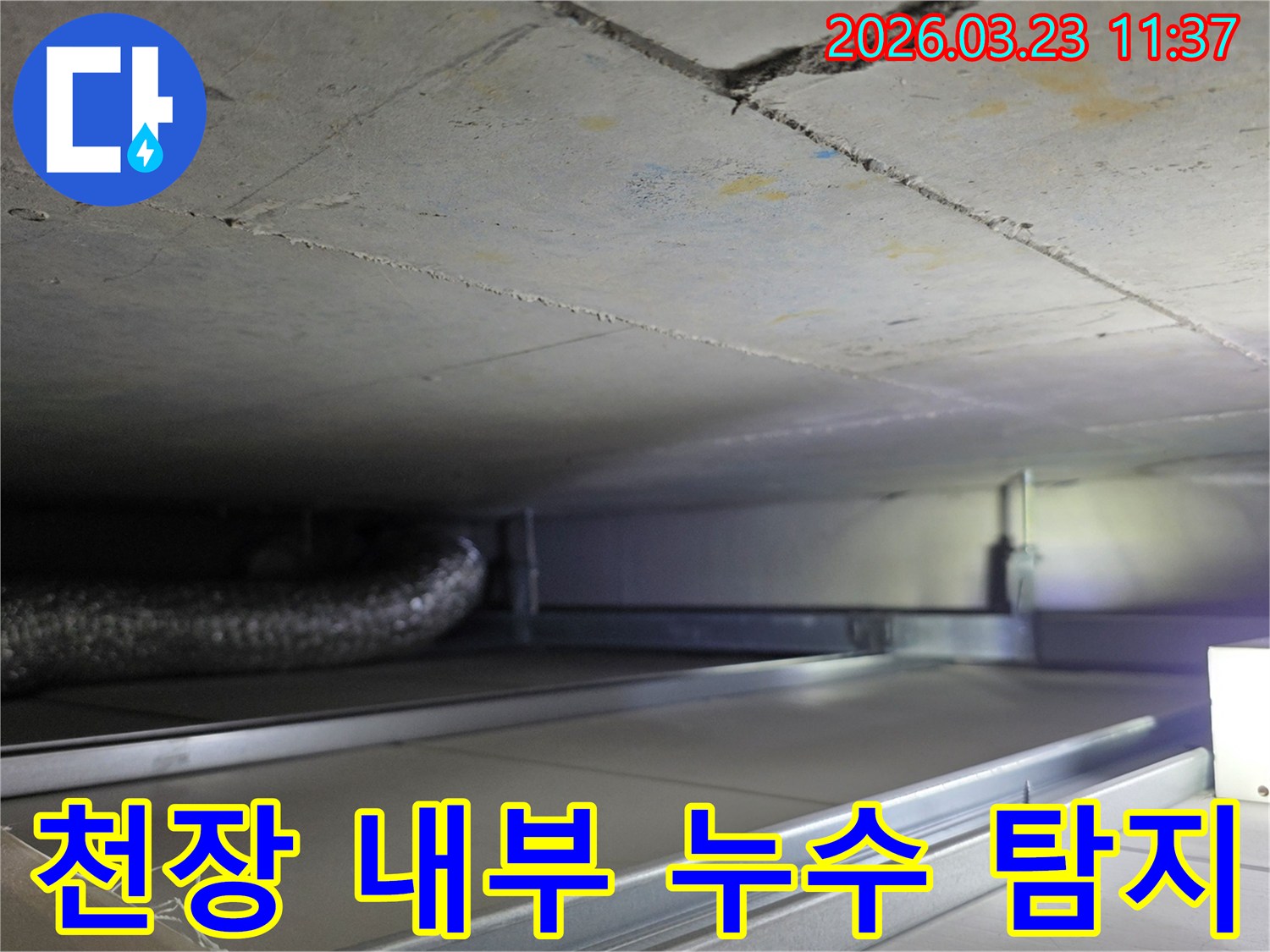 누수 공사 중-천장 내부의-복잡한-배관과-구조물을-면밀히-검토하는-과정을-보여주는-사진입니다