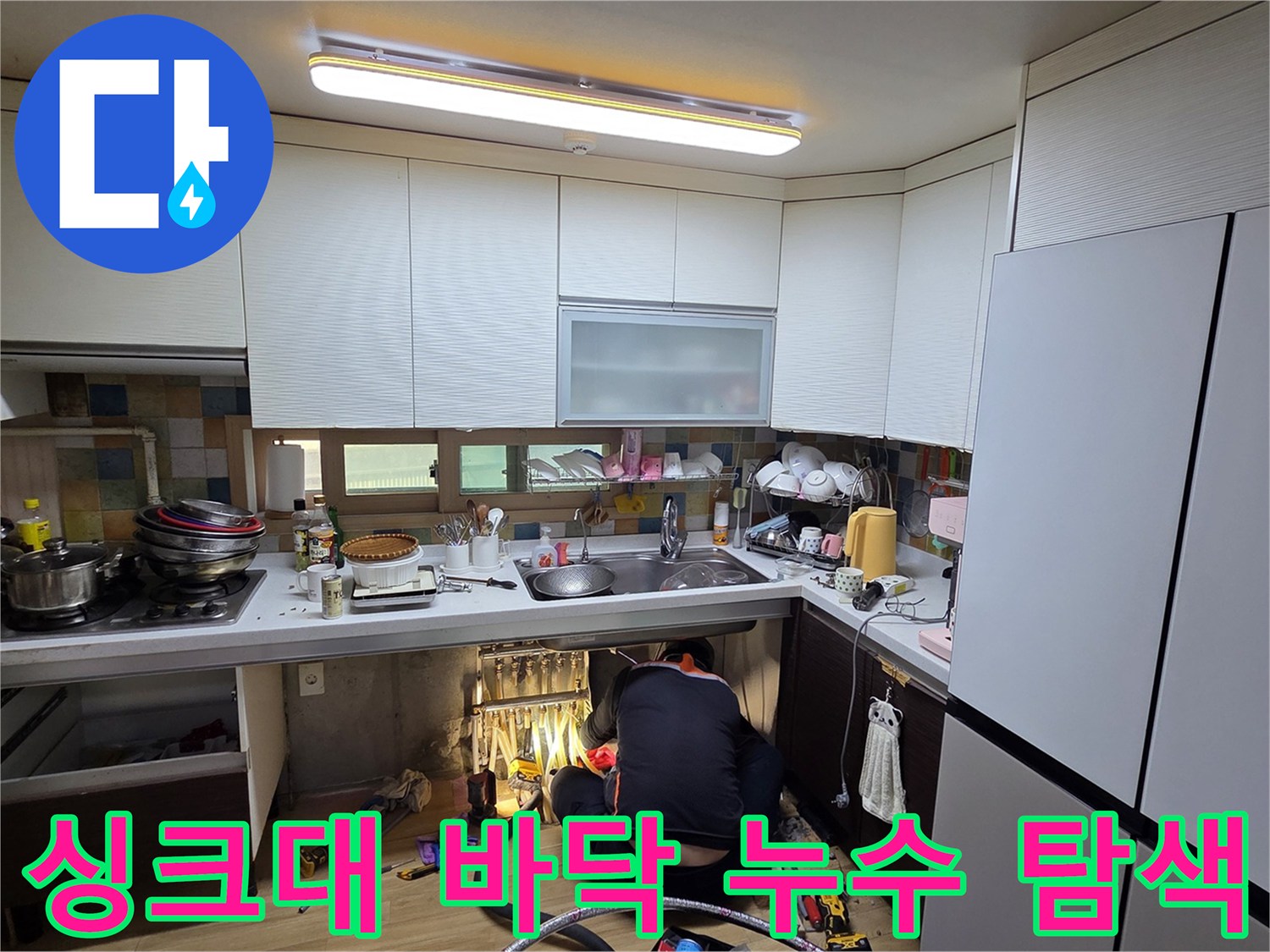 싱크대 하부장 아래쪽의 굴착 및 배관 점검 작업 중인 현장