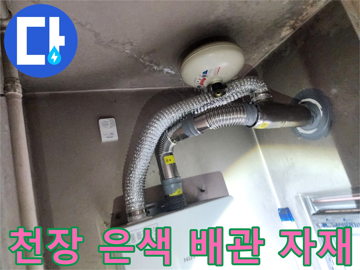 천장에 설치된 보온 처리가 된 금속 재질의 배관과 부속품