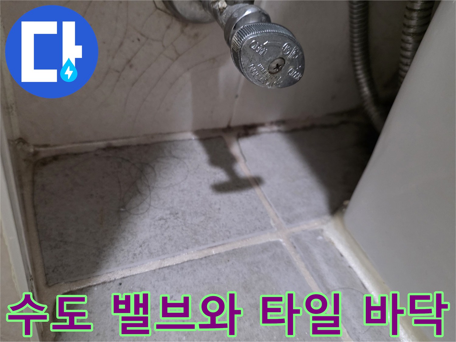 벽면 수도 밸브 아래쪽 타일의 상태를 촬영한 이미지입니다.