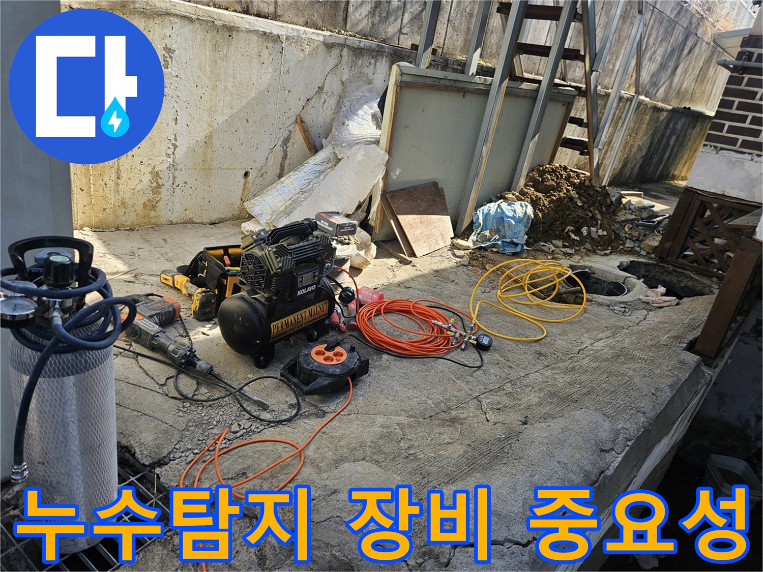 누수 공사를 위한-에어 콤프레셔-함마드릴-호스-전선릴 등-다양한 전문 장비들이-콘크리트 바닥 위에-정돈되어 있는-작업 준비 현장