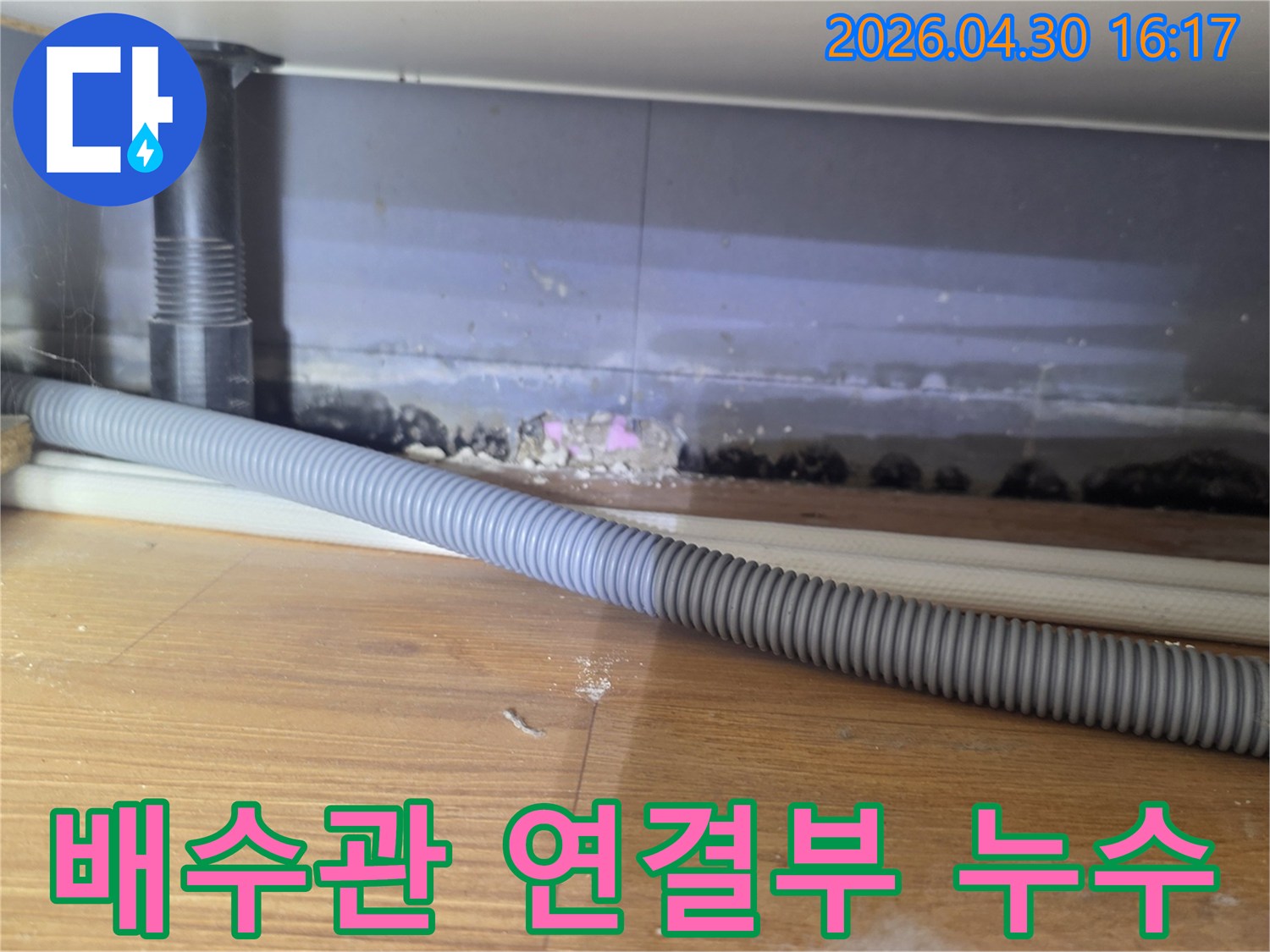 싱크대 하부 배수관 연결부에서 발생한 누수로-인해 바닥과 벽면이 오염된 현장 사진