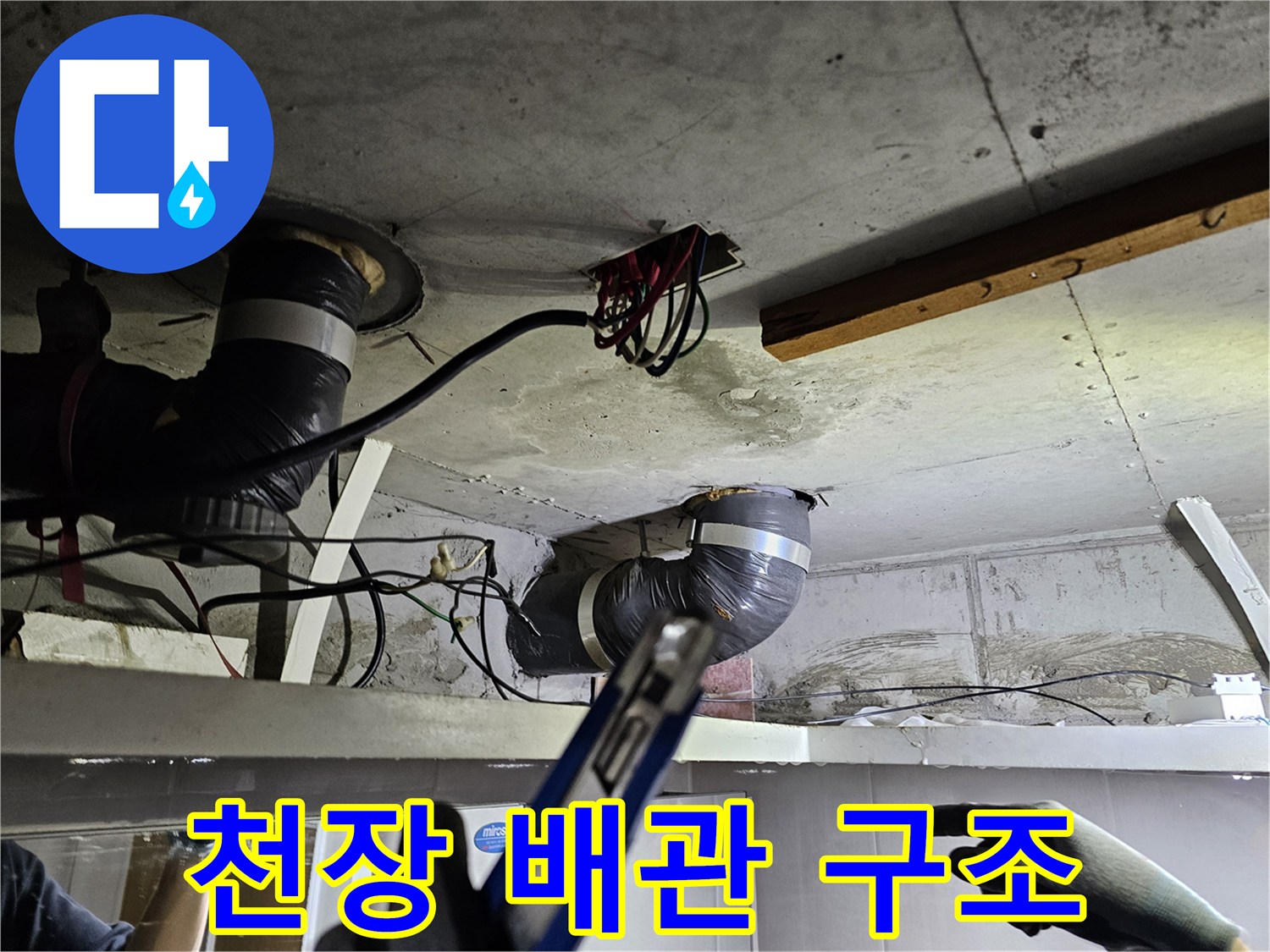 콘크리트 천장 아래- 다양한 배관과 전기선이- 복잡하게 얽혀 있는 내부 구조