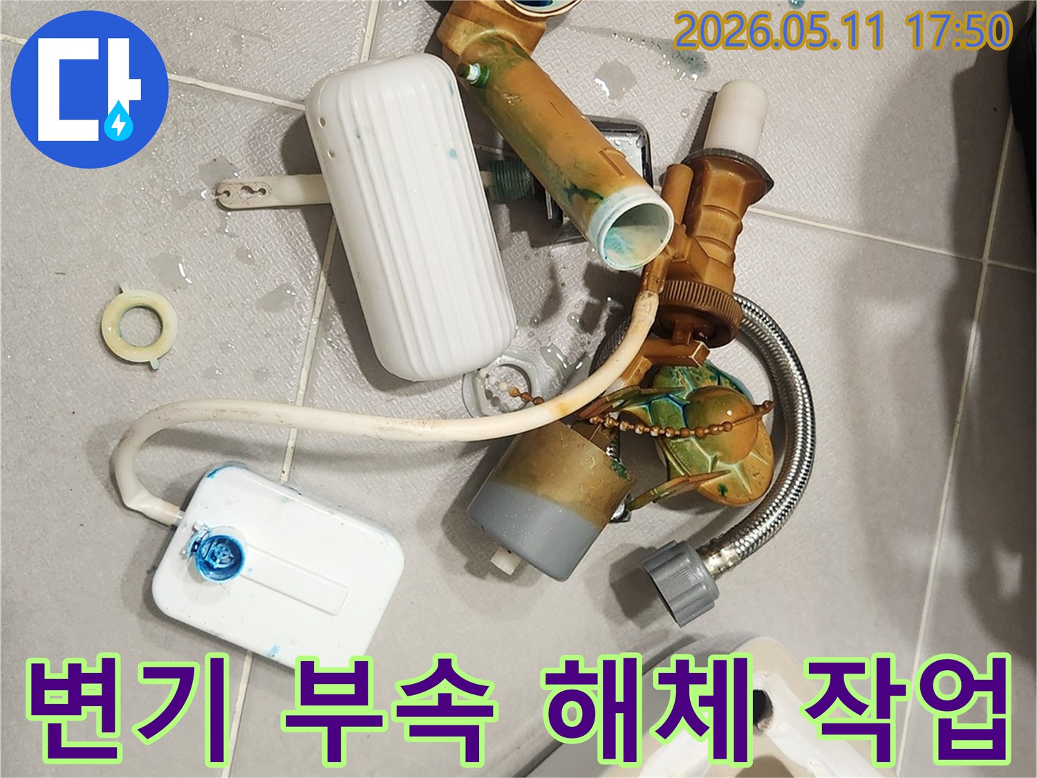 안방 변기에서 발생한 물샘 문제를 해결하기 위해-오래된 변기 부속들이 해체되어 바닥에 놓여 있는 모습입니다-새 부품으로 교체하여 변기를 수리할 예정입니다