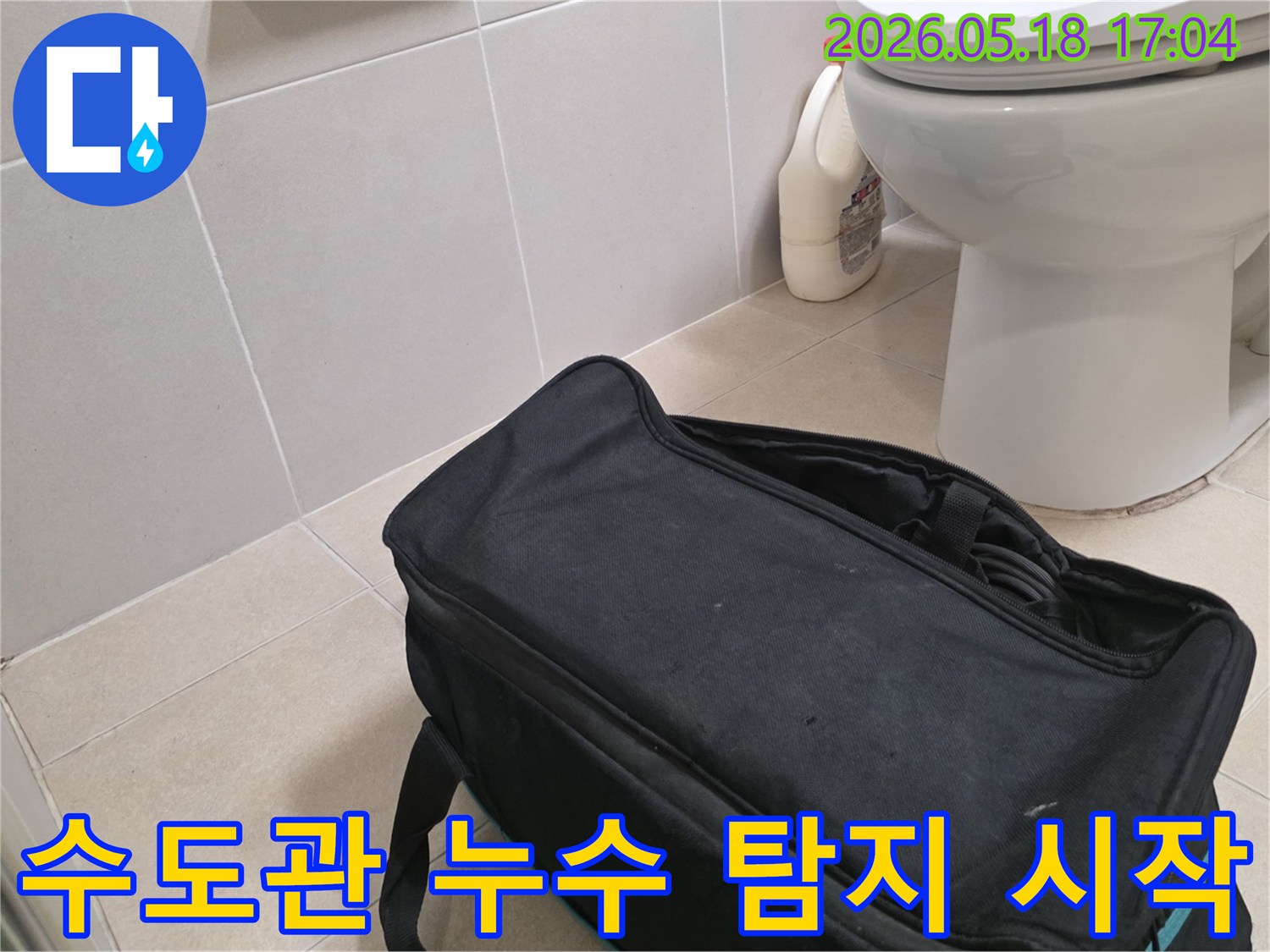 누수 전문가가 구산동 아파트 욕실에서-수도관 누수 확인을 위해-탐지 장비를 준비하는 장면입니다