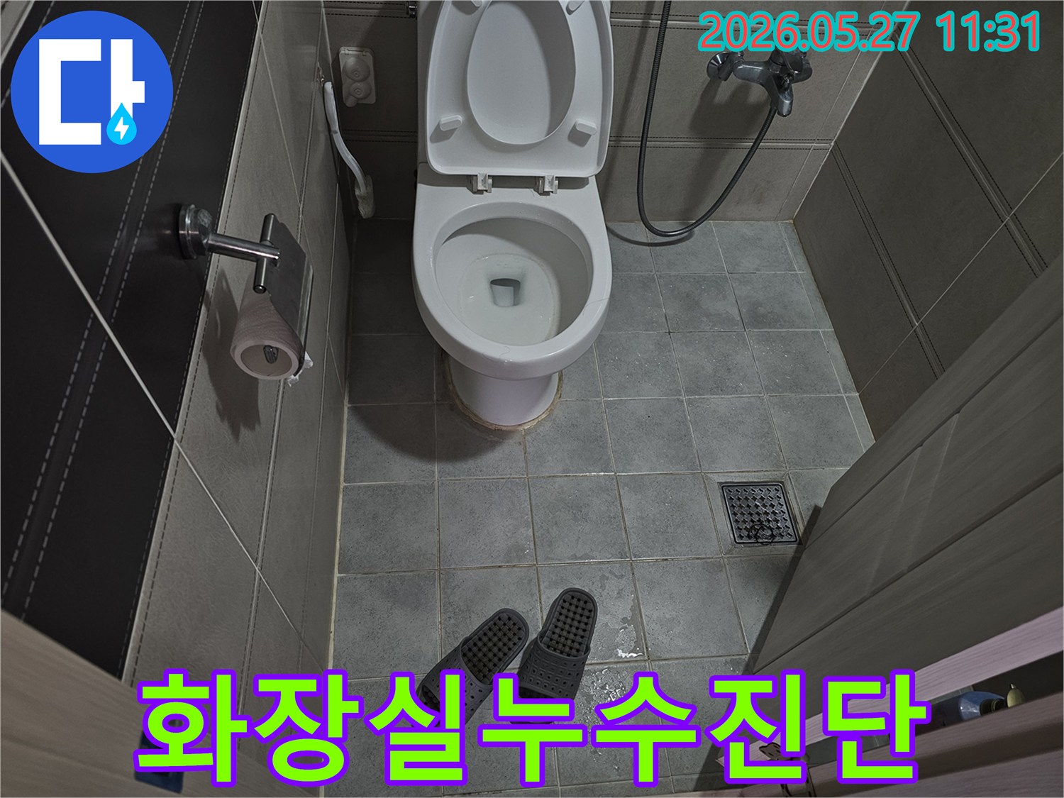 화장실-바닥-타일-위에-물이-고여있고-슬리퍼가-놓여있는-누수-현장-사진