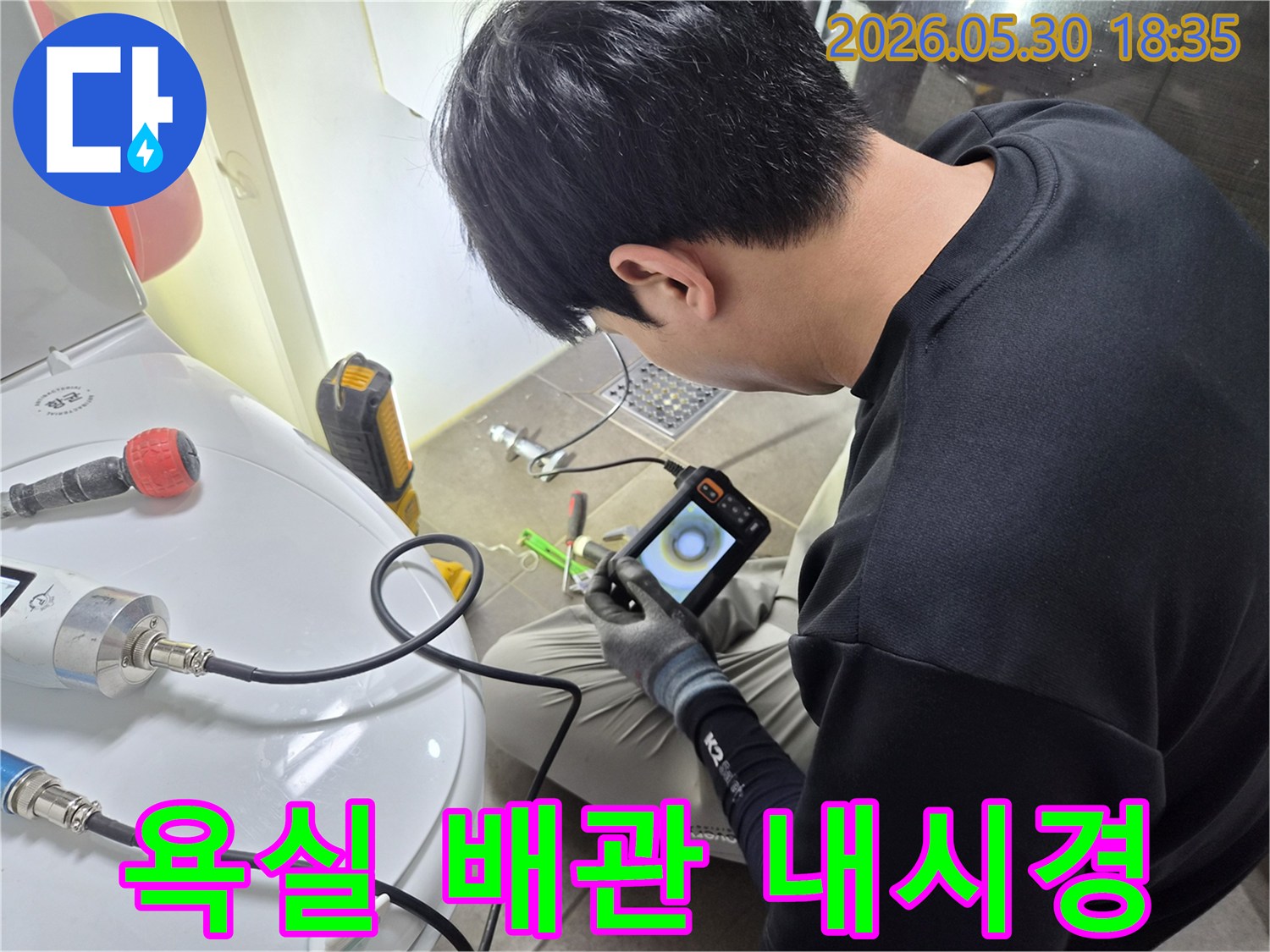 누수 탐지 전문가가-욕실 배관 내부를-내시경 카메라로-세밀하게 조사하고 있습니다