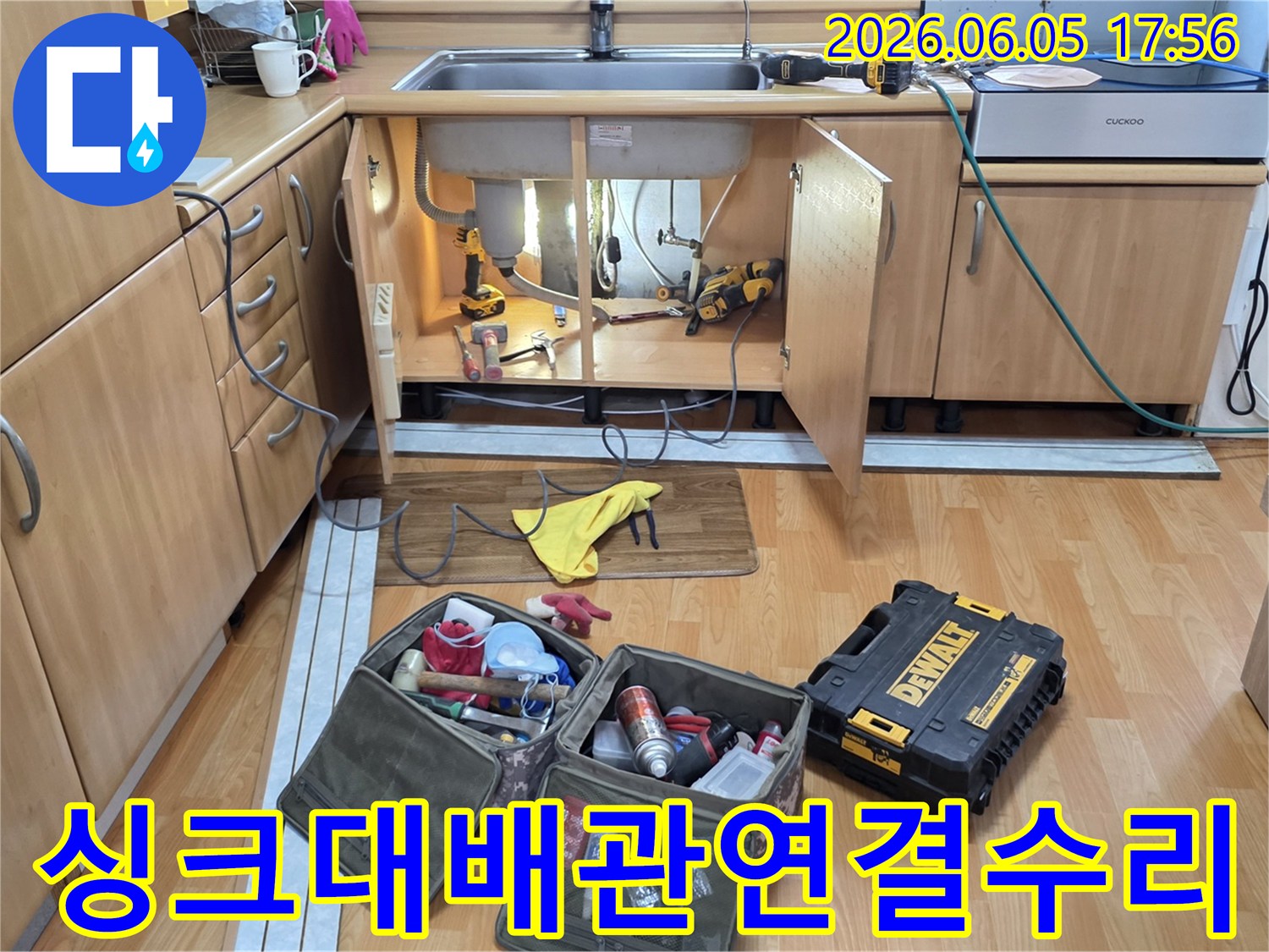 싱크대 하부의 배관 연결 부위-누수를 해결하기 위해-전문 공구들이-준비된 작업 현장입니다.