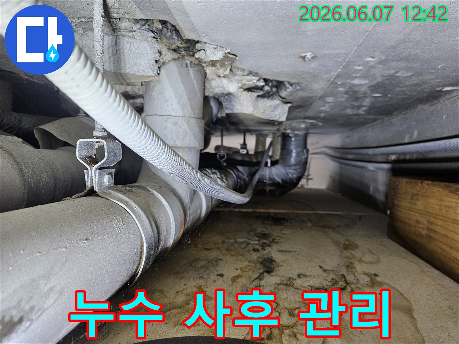 배관에서 물이 새어 나와-바닥에 물자국과-습기가 가득한-누수 현장의 모습입니다.