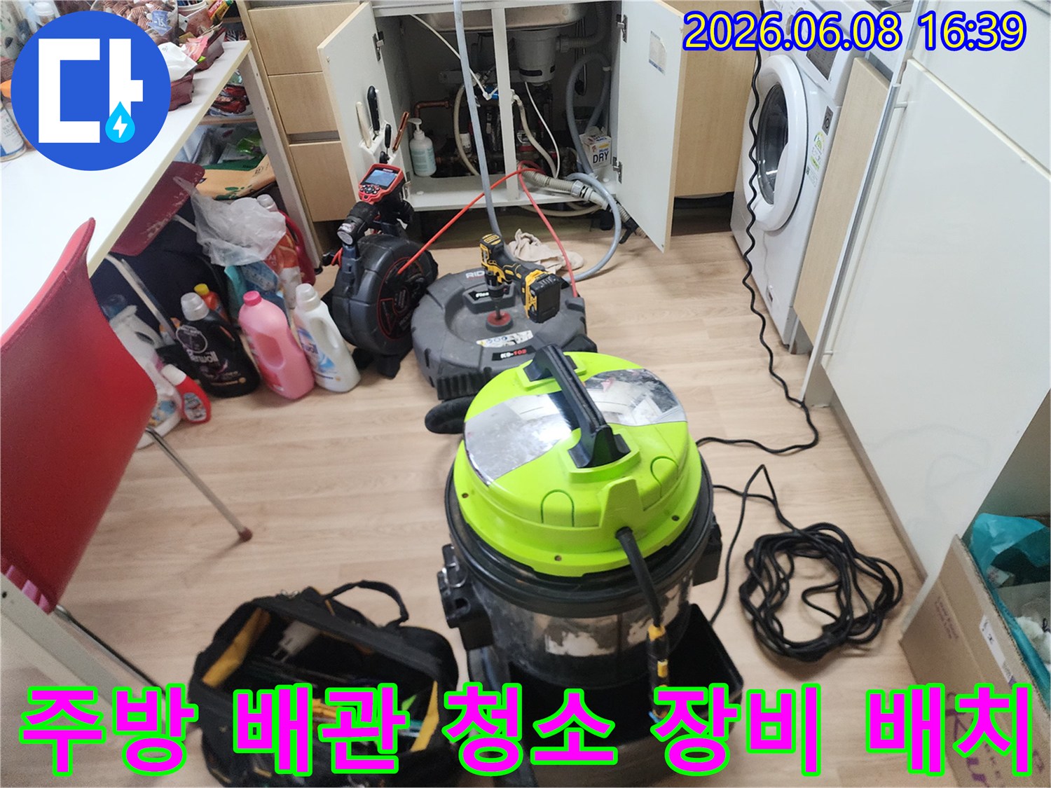 싱크대 아래쪽 공간에 놓인 강력 석션기와 작업용 케이블입니다.