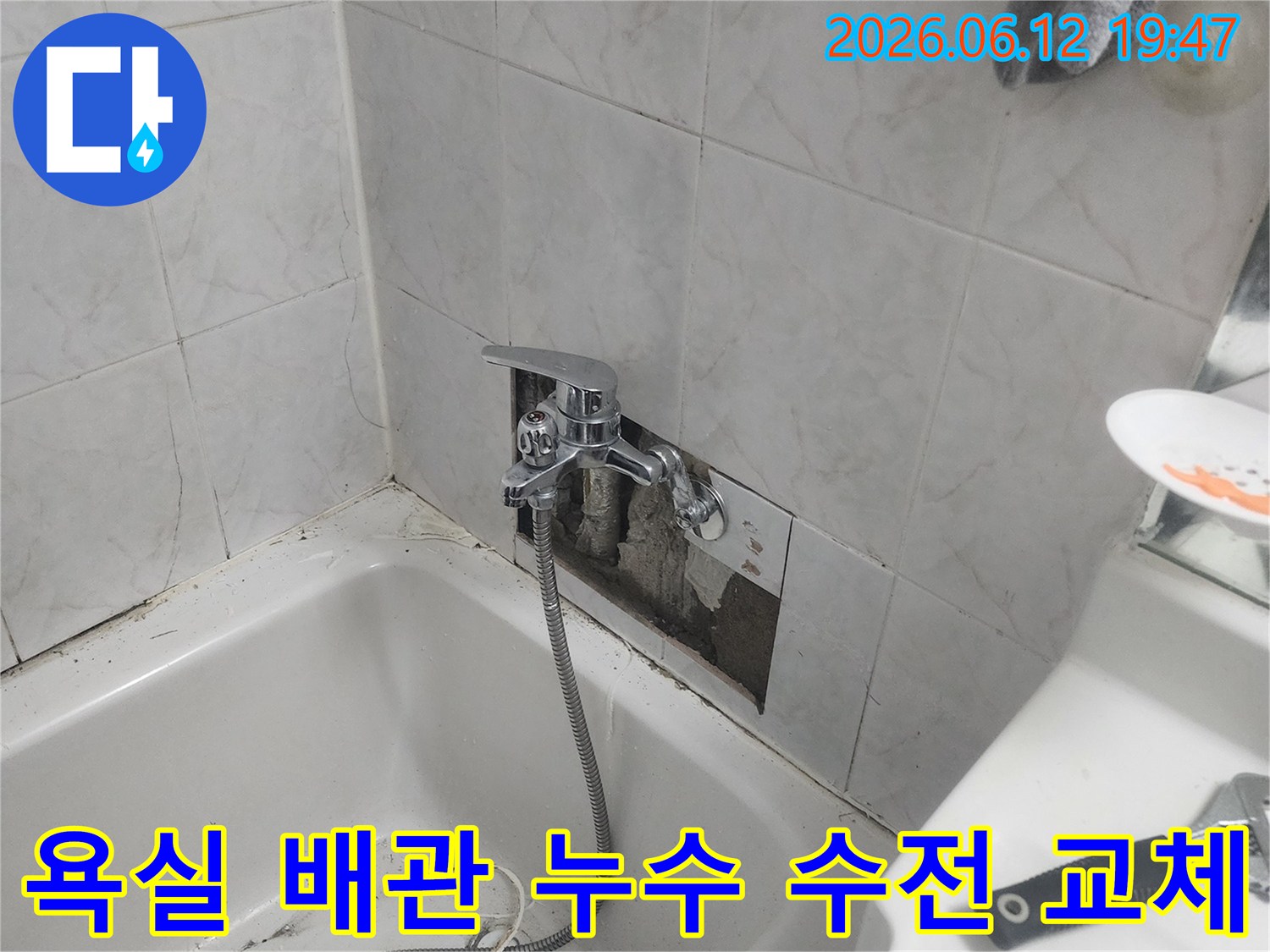 누수로 인해 욕실 벽면 타일이 제거되고-새로운 수도 수전이-설치되는-보수 작업의-진행 상황을-보여주는-이미지입니다.