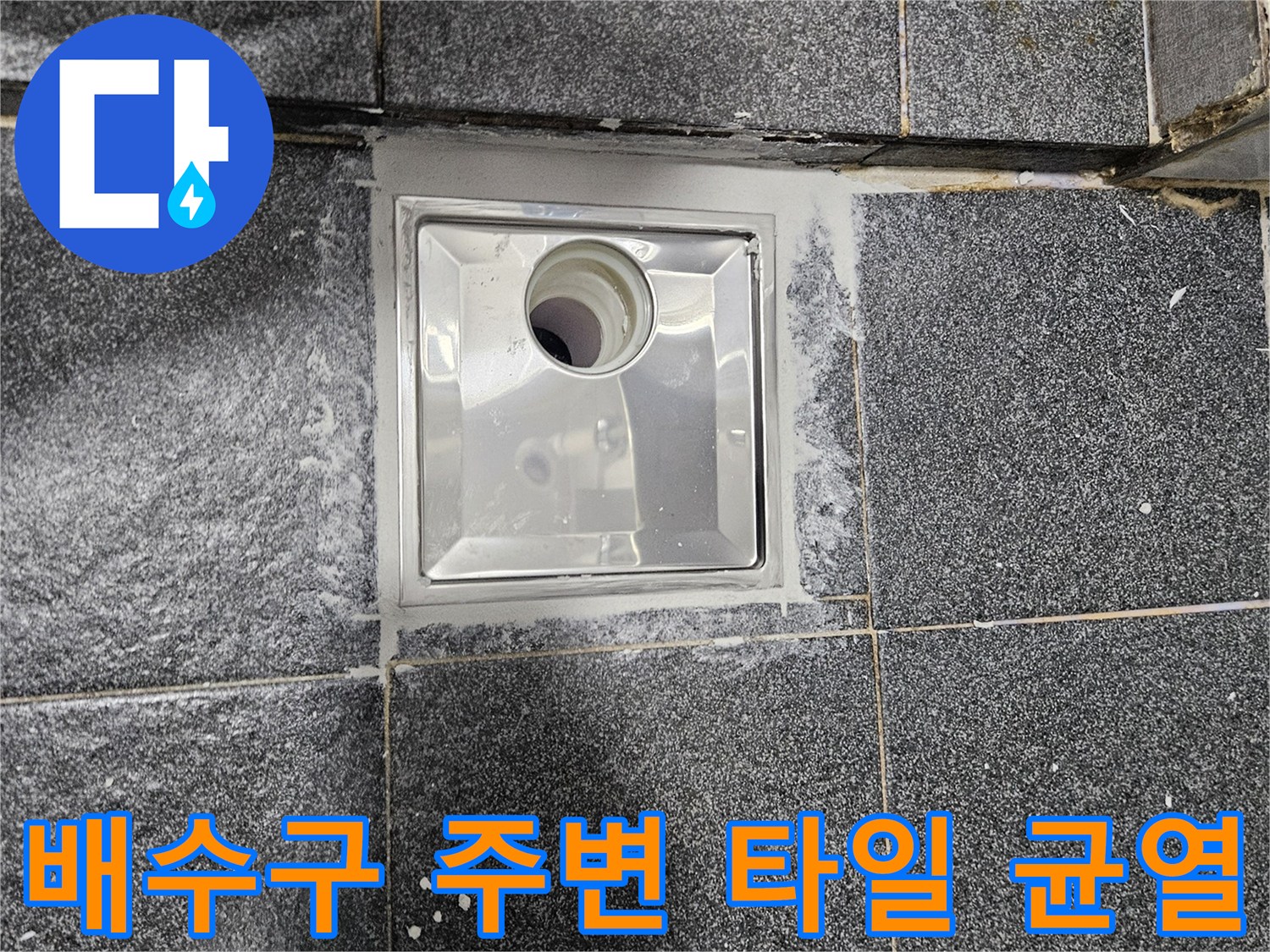 타일과 배수구 유가 사이의 벌어진 틈새를 근접 촬영한 사진입니다.