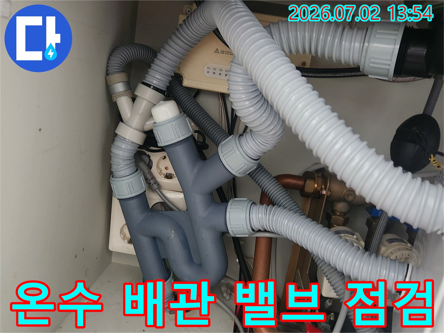 이 사진은-싱크대 하부의-구리 온수 배관과-밸브를 세밀하게-보여주며-급수관 누수 원인을-파악하는 데-중요한 부분입니다.