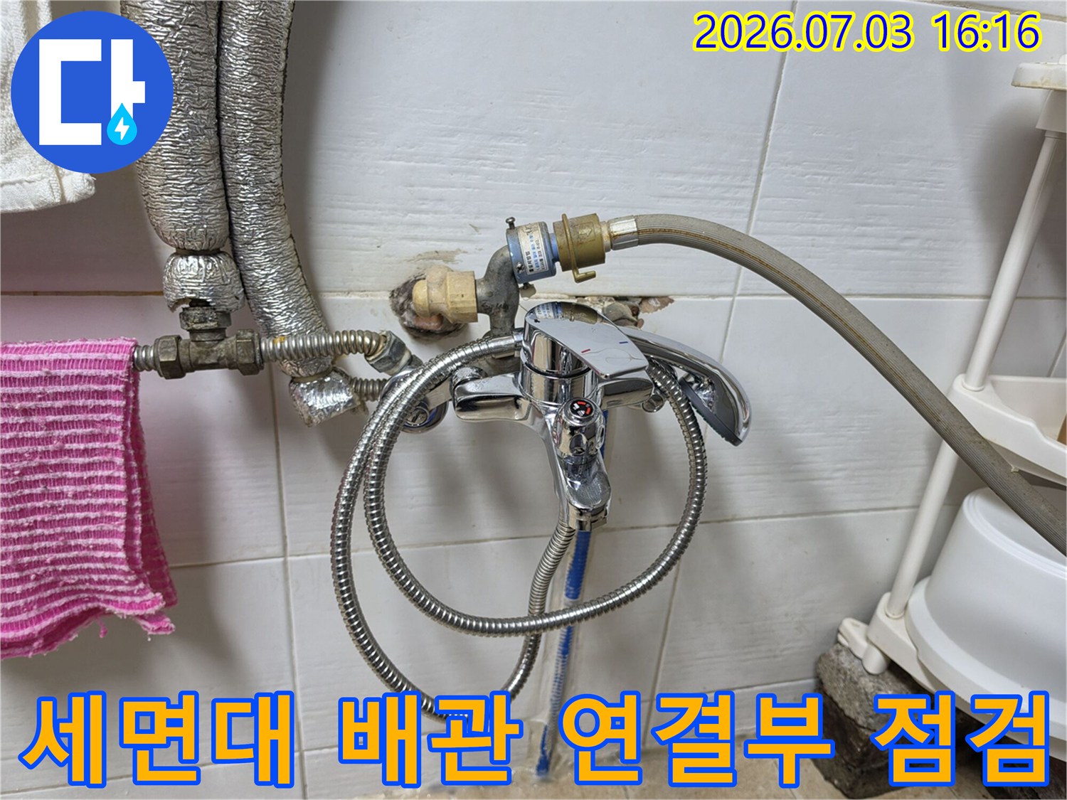세면대 아래쪽 노출된 수도 배관과 수전 연결 부위의 상세 모습