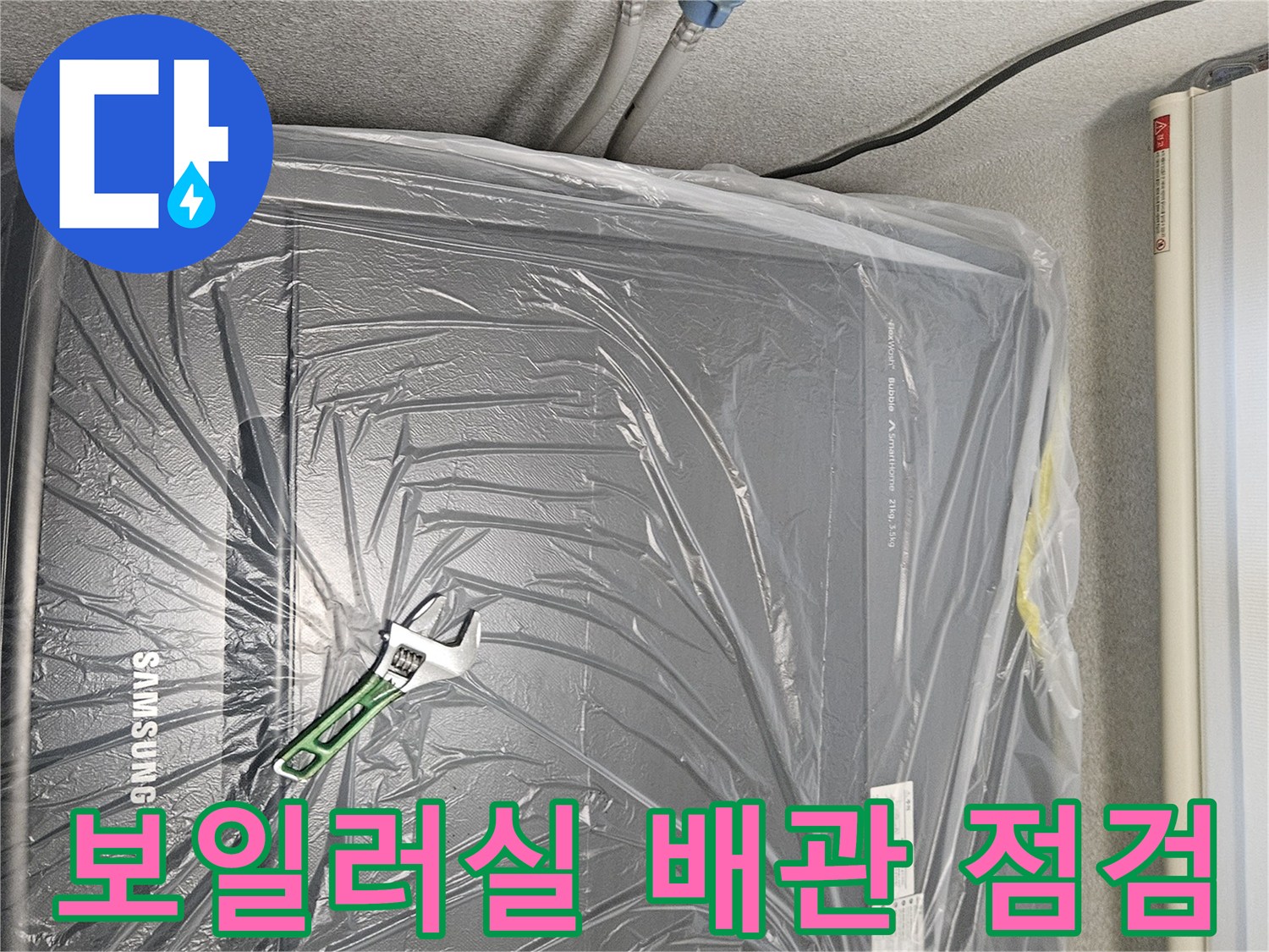 보일러 배관 연결 부위와 몽키스패너가 놓여 있는 모습