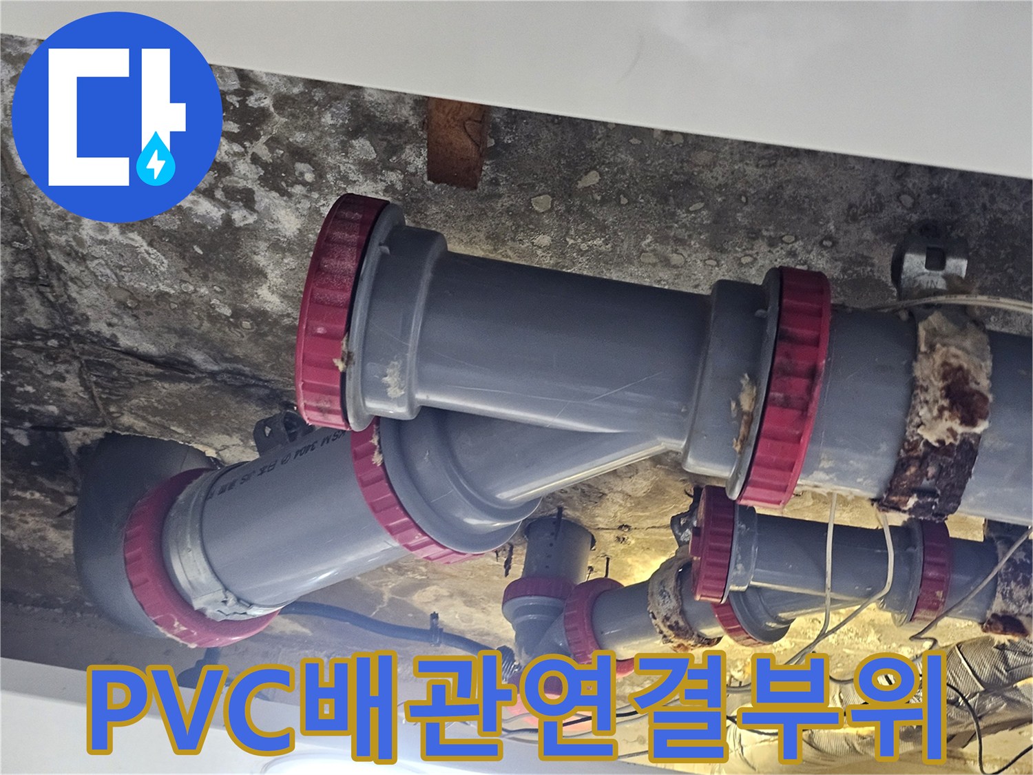 물샘 증상이 발견된 PVC 배관과 붉은색 소켓 부속의 모습