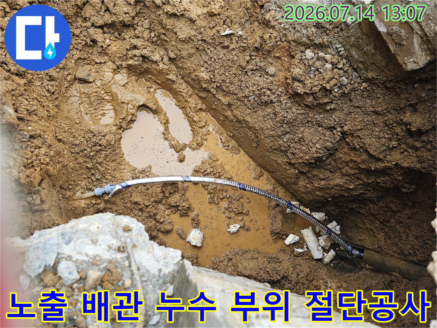 흙 속에서 꺼낸 파란색 배관의 누수 지점을 확인하고 보수를 준비하는 과정의 사진