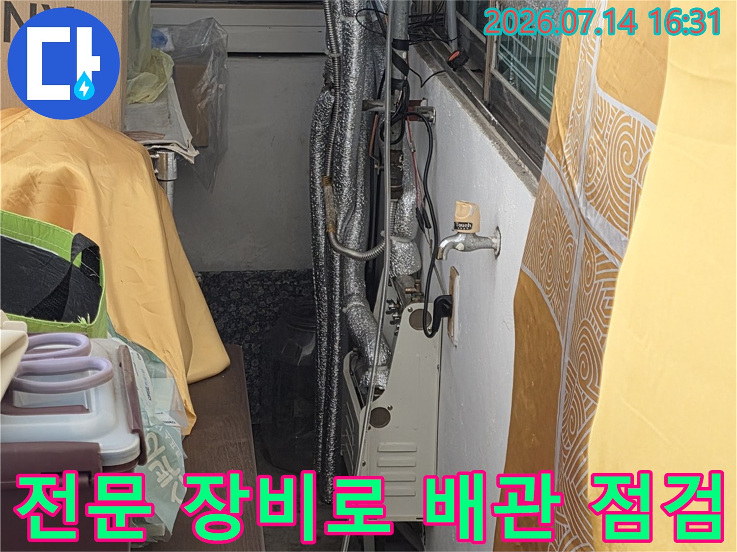 배관보온재를 벗겨내고 노출된 파이프에 압력 체크용 계측기를 연결한 모습