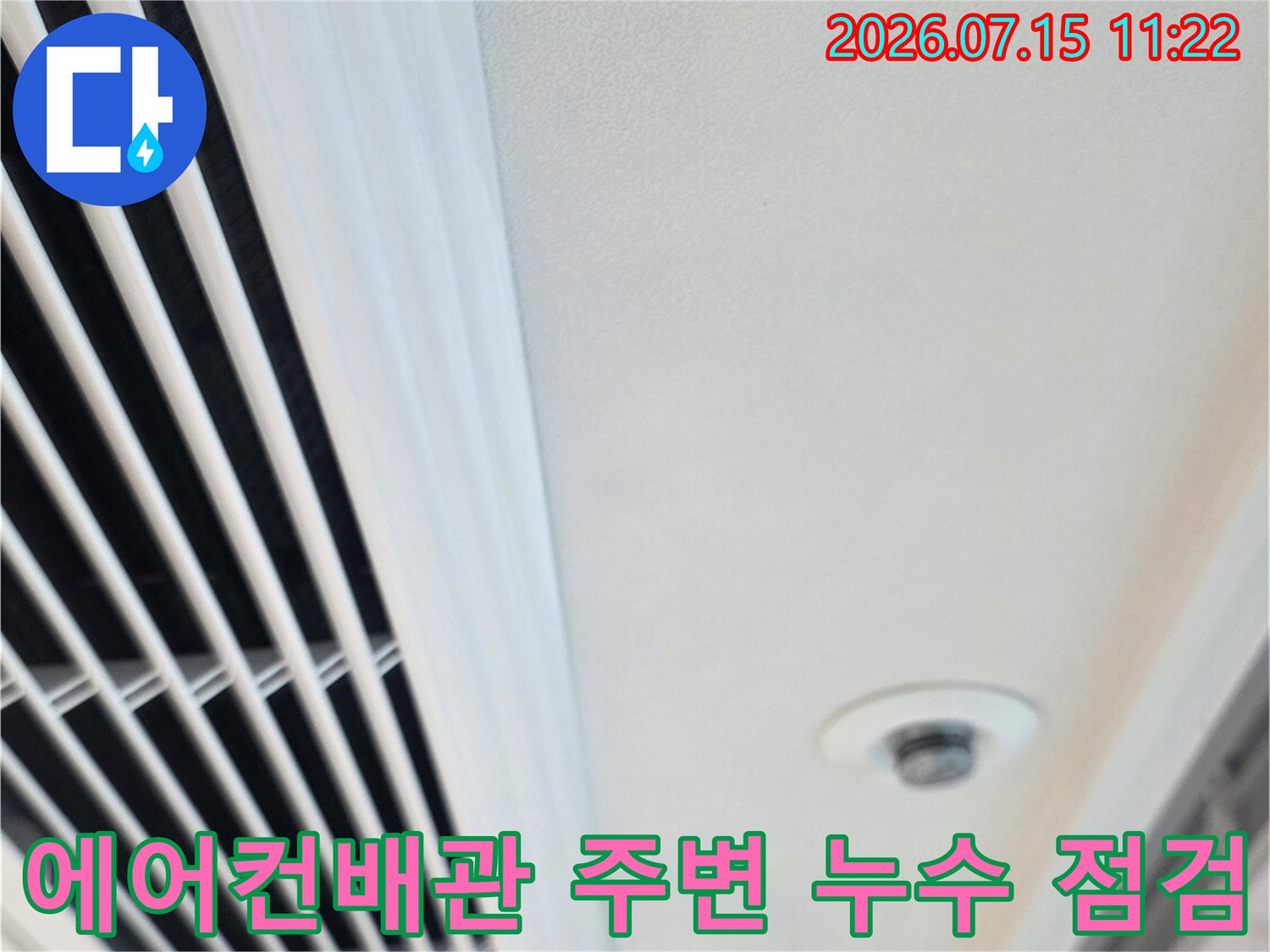 에어컨 배관과 가림막이 설치된 천장 내부를 점검하는 모습