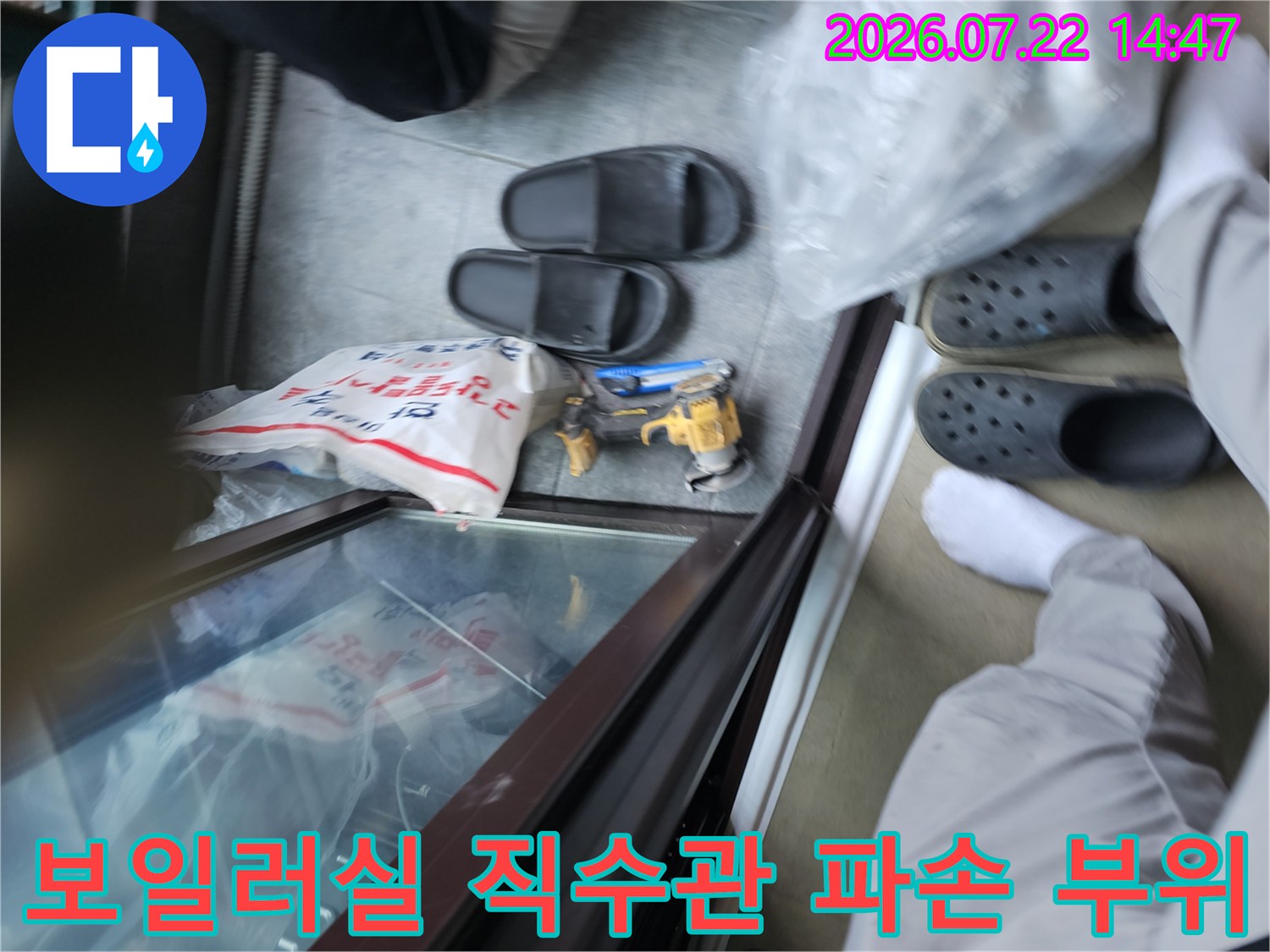 보일러실 내 노란색 배관의 파손 부위와 작업 도구들이 놓인 모습