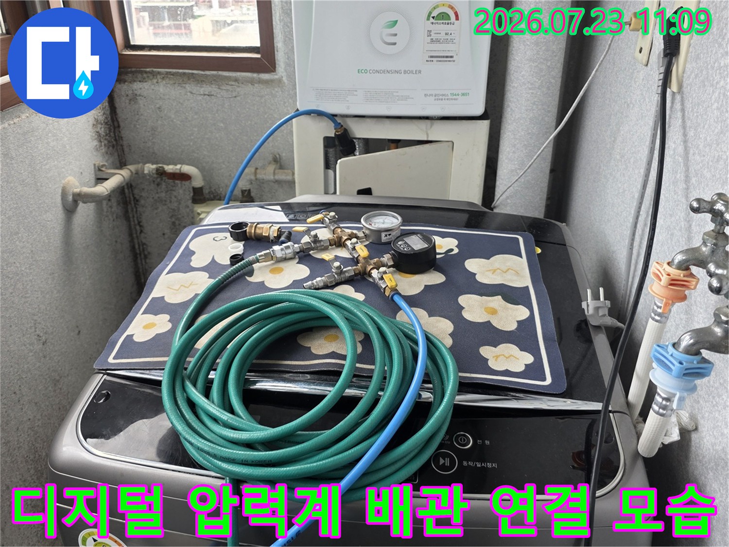 꽃무늬 천 위에 배치된 누수 탐지용 호스와 디지털 측정 장비-배관 연결부