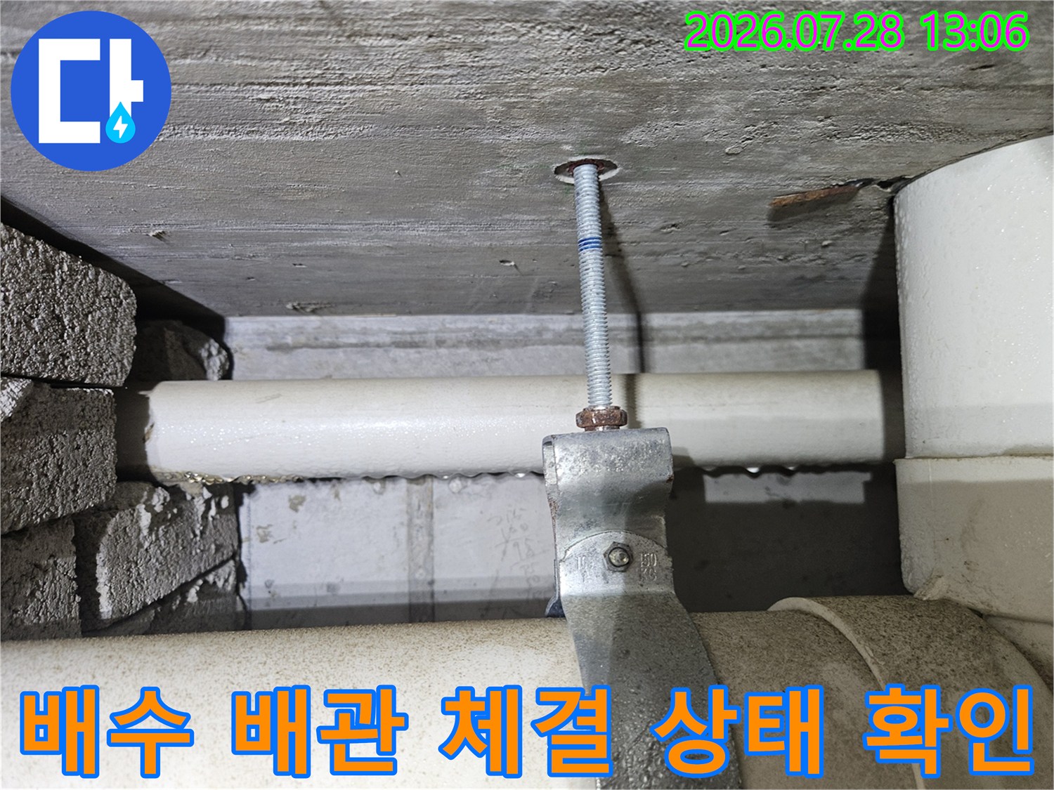 노후된 주방 하수 배수 배관의 연결부체결 상태를 상세히 촬영한 사진입니다.