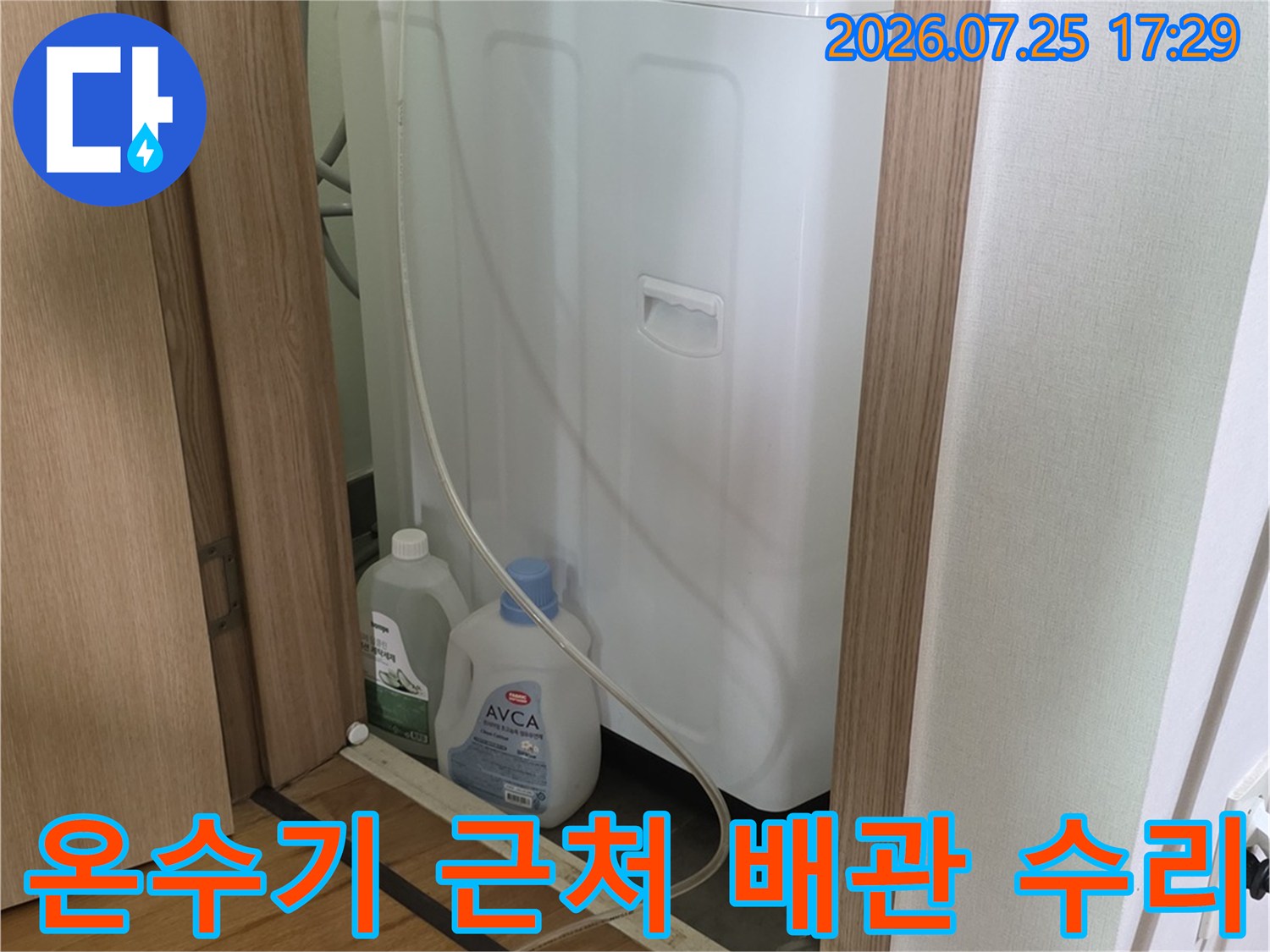 온수기 옆에 설치된 배관과 노출된 수도 계량기가 있는 현장 모습
