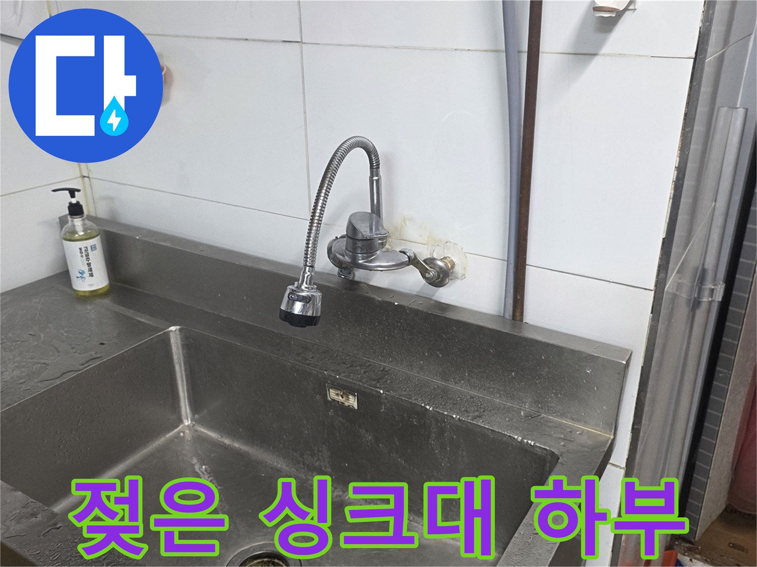 물기가 맺혀 있는 스테인리스 싱크대와 수전 근처입니다.