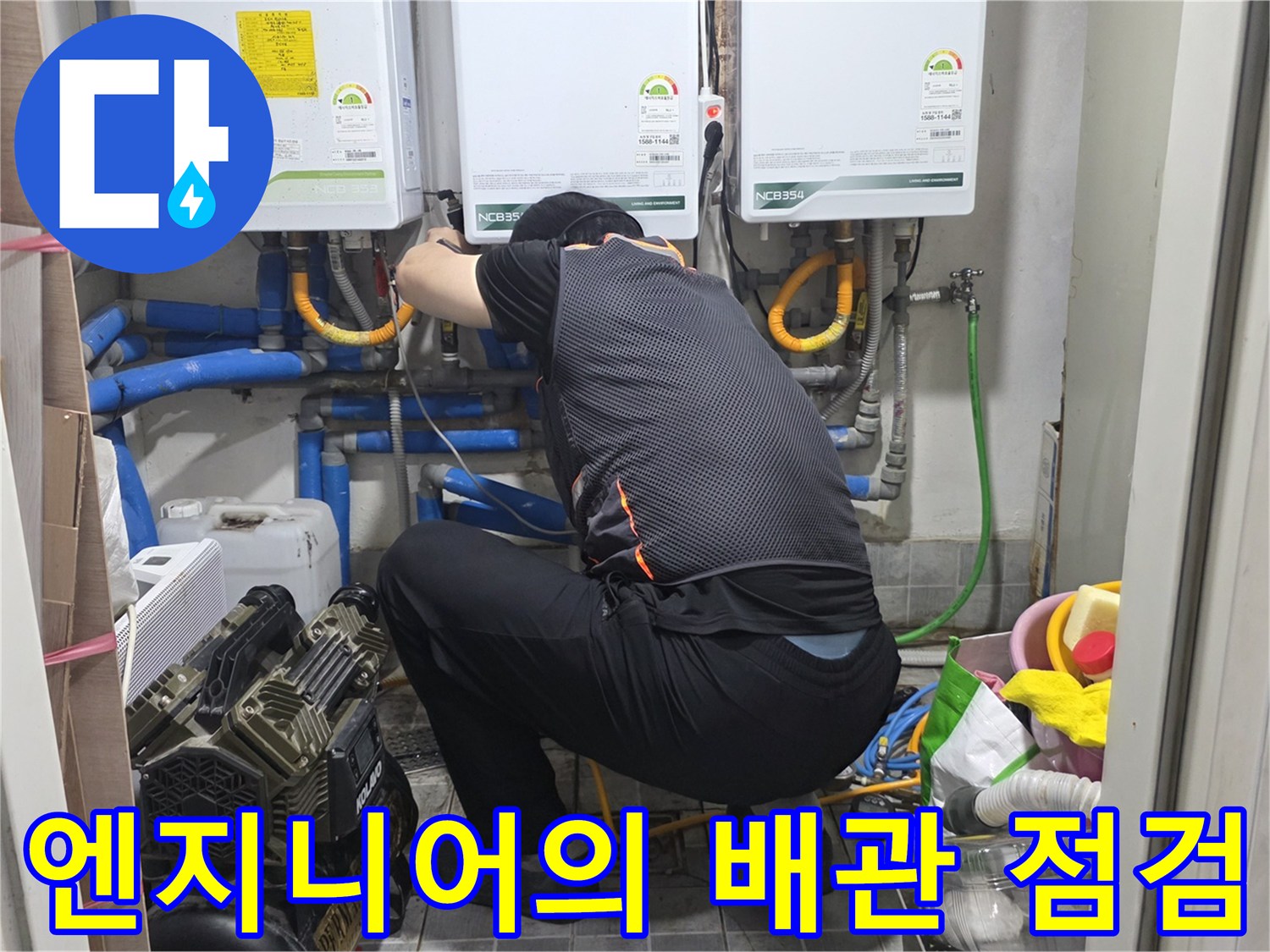 보일러 하단부 배관 구조를 확인하며 작업을 진행하는 엔지니어