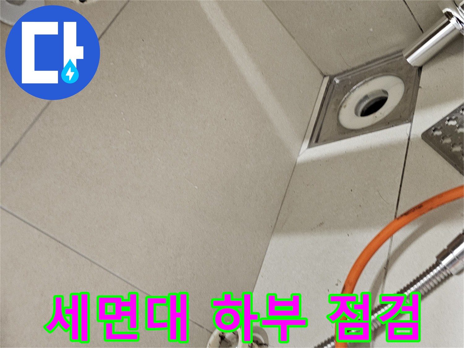 벽면에 노출된 세면대 배수구와 샤워기 호스의 연결 상태