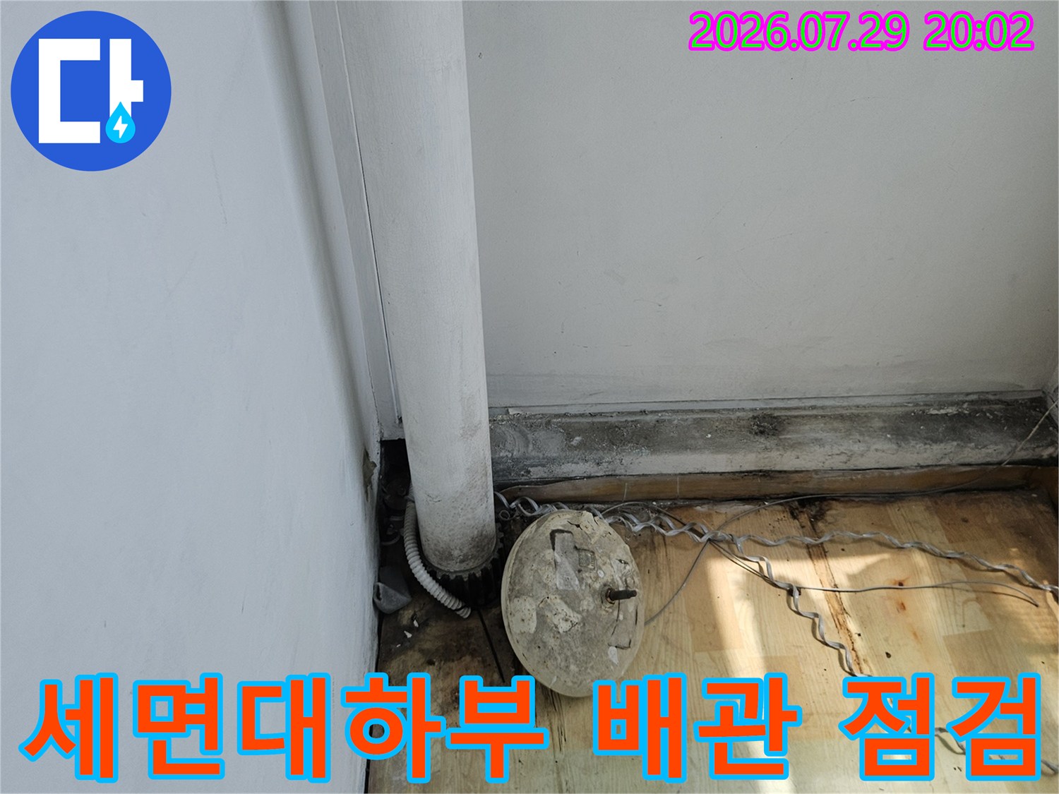 세면대 하단 노출된 수도 배관과 계량기 연결 부위 점검 장면