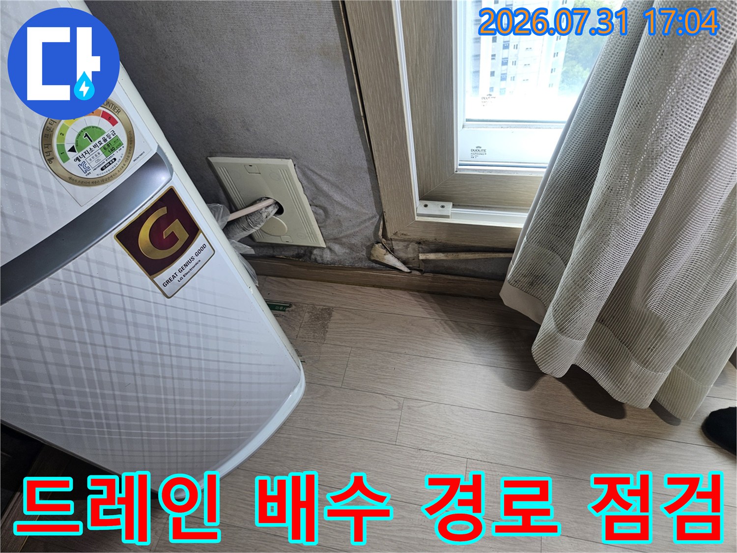 에어컨 하단부 드레인 호스의 곡선과 연결 상태를 확인하는 현장 사진입니다.