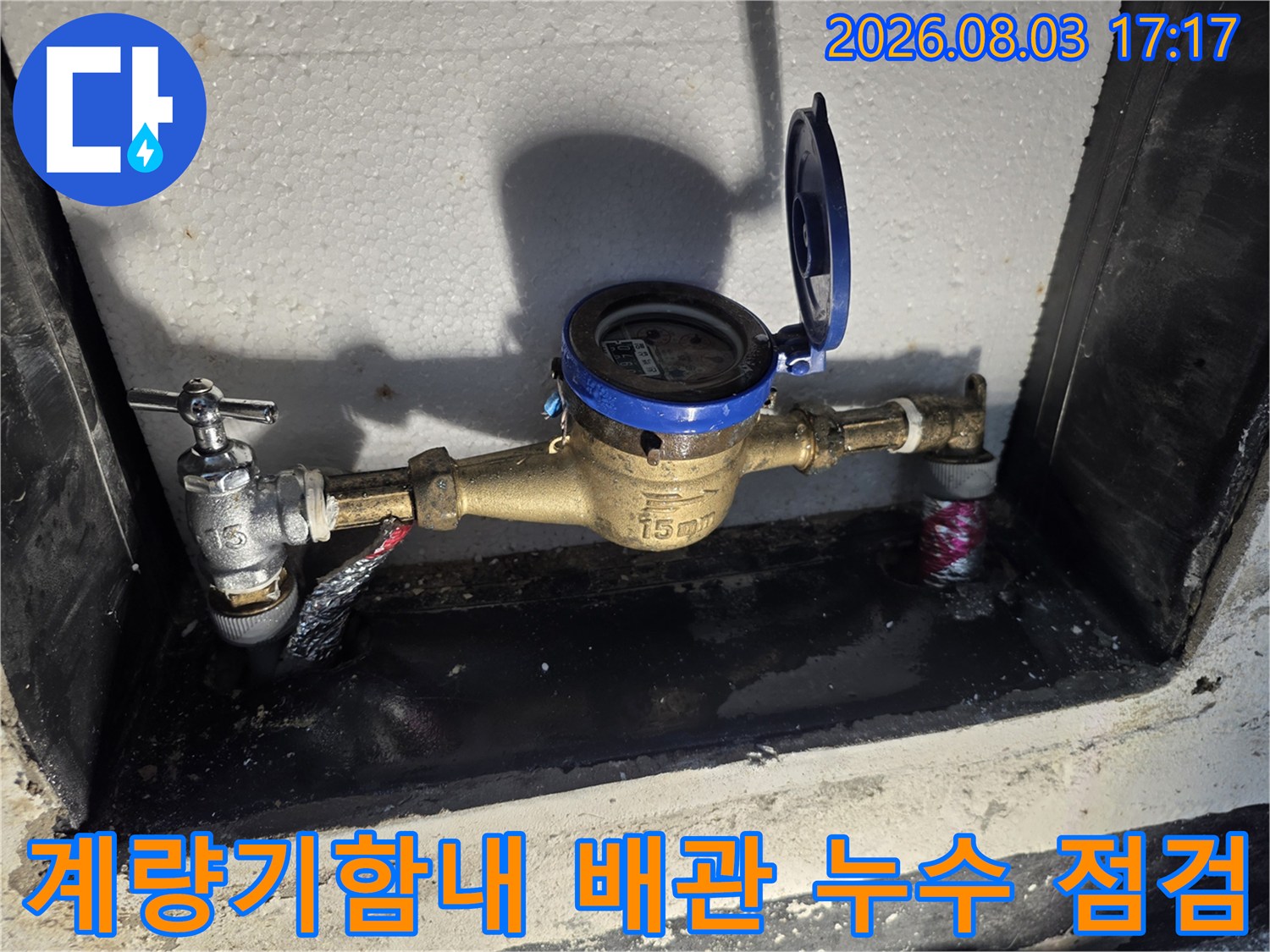 계량기함 내부의 노출된 수도 배관과 계량기를 점검하는 모습